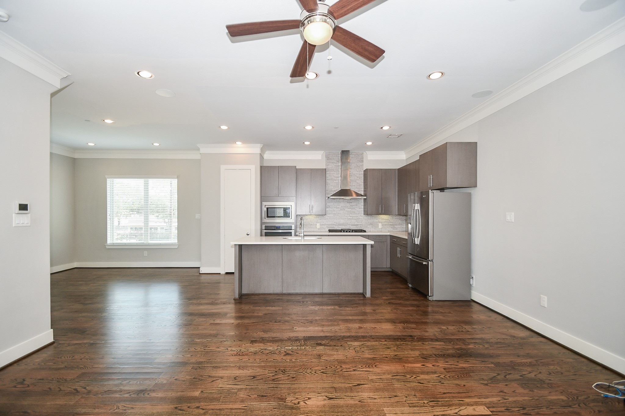 chef's Kitchen boasts Fabulous Finishes with Quartz Counter tops, designer tile backsplash, five-burner gas stove stainless steel appliances and large island for extra prep-space and seating. Separate Micro-Wave and Oven