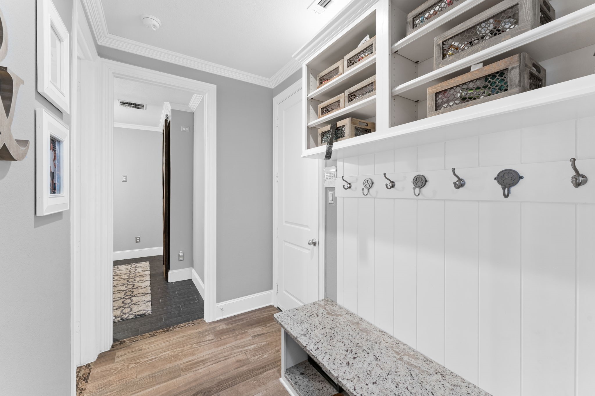 Mudroom with granite seating and shoe storage.