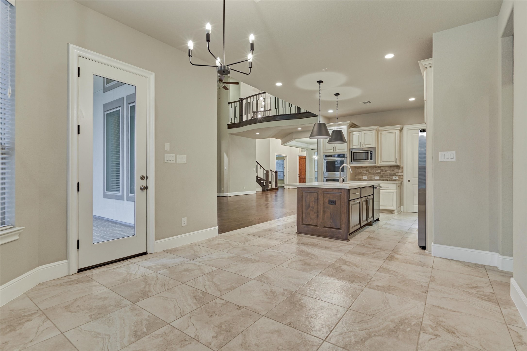Neutral ceramic tile covers the kitchen and breakfast nook floors.
