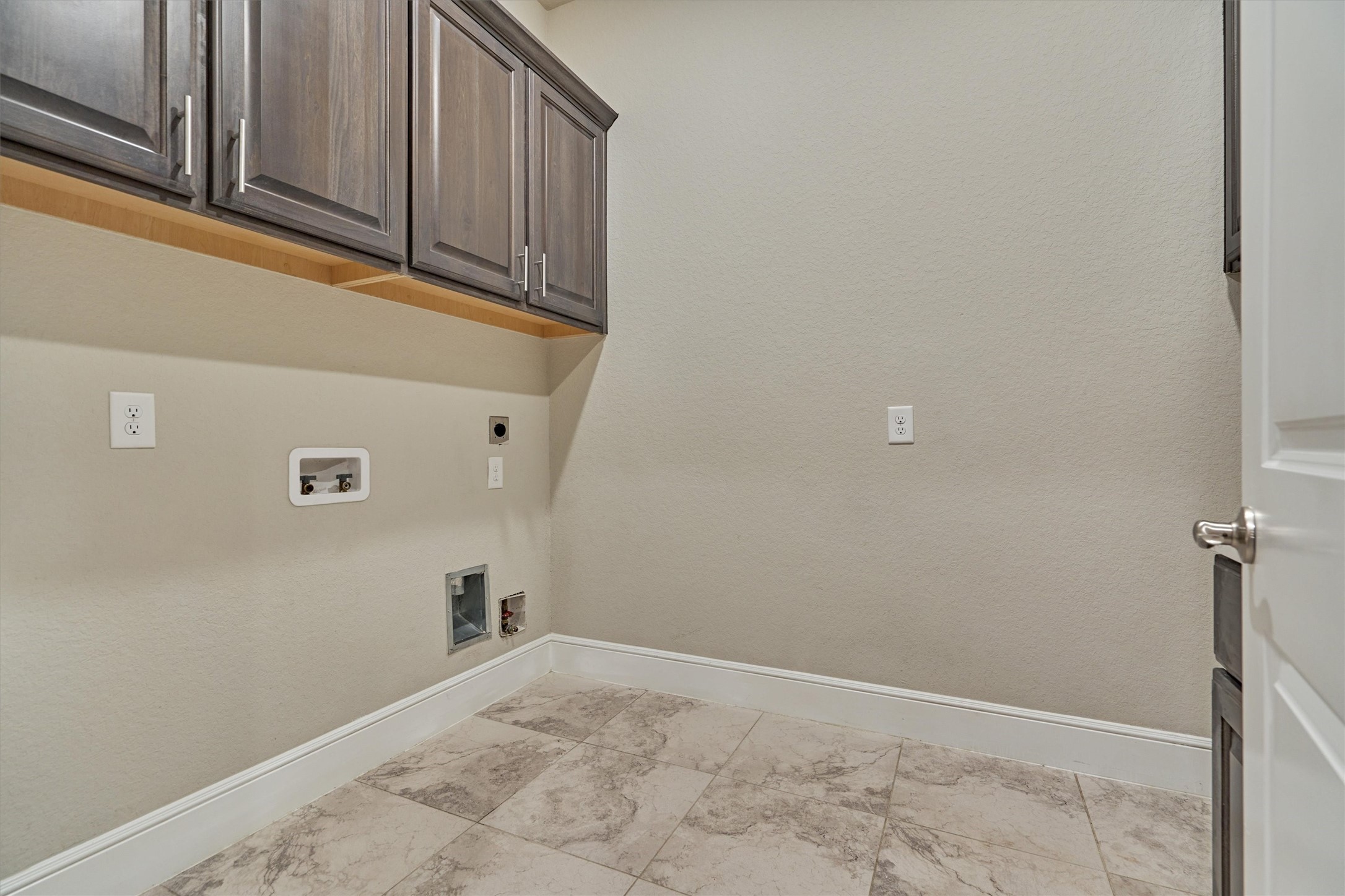 A spacious laundry room with washer and dryer connections, perfect for busy households.
