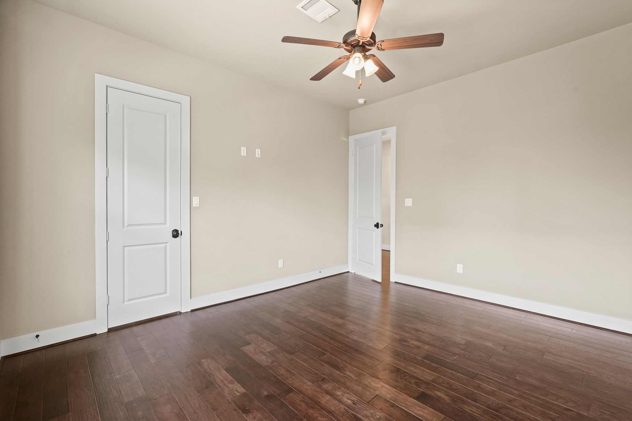 3rd upstairs bedroom features wood flooring and walk in closets.