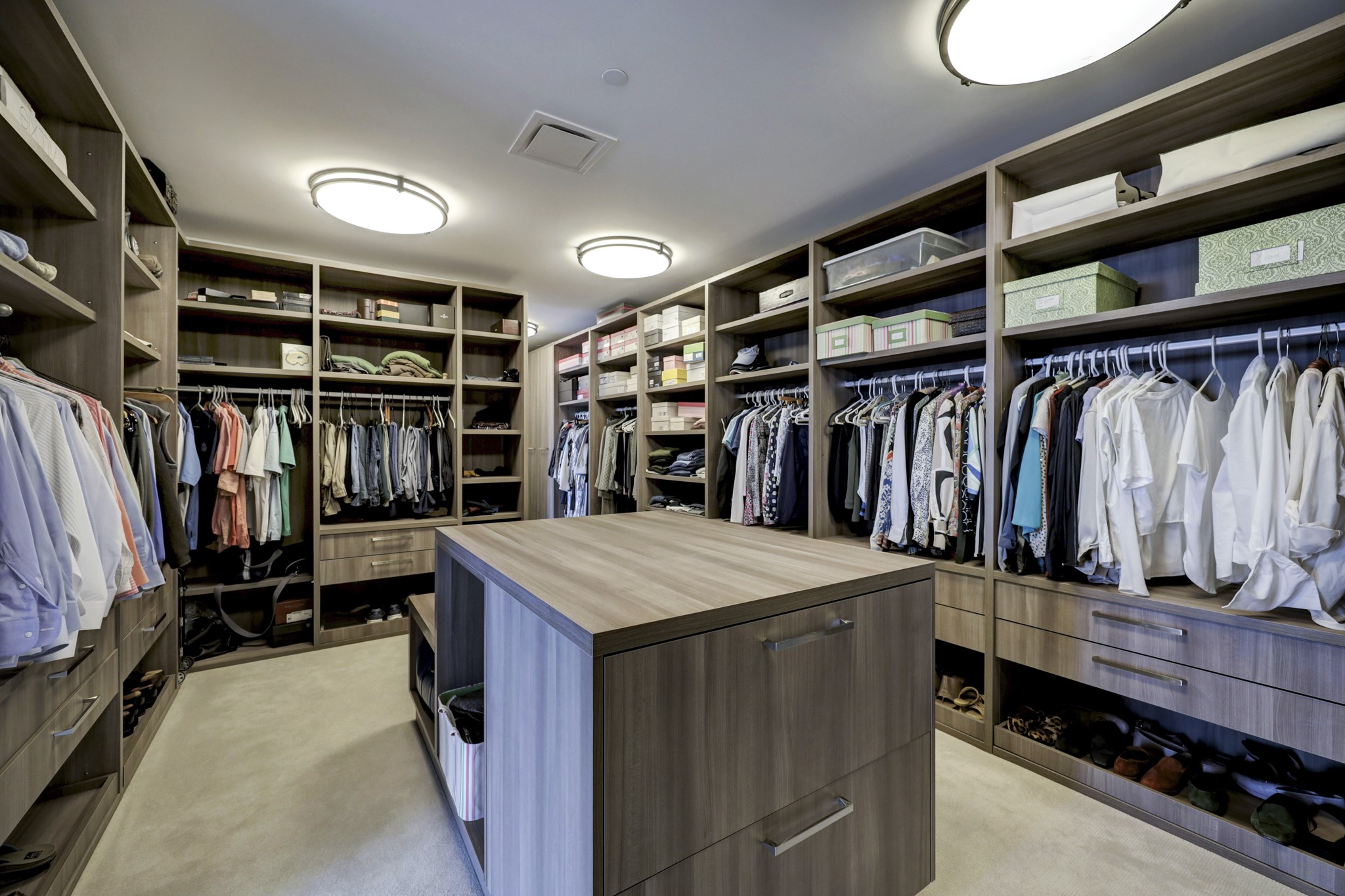Custom designed closet with a thoughtful design and a center storage and packing counter.
