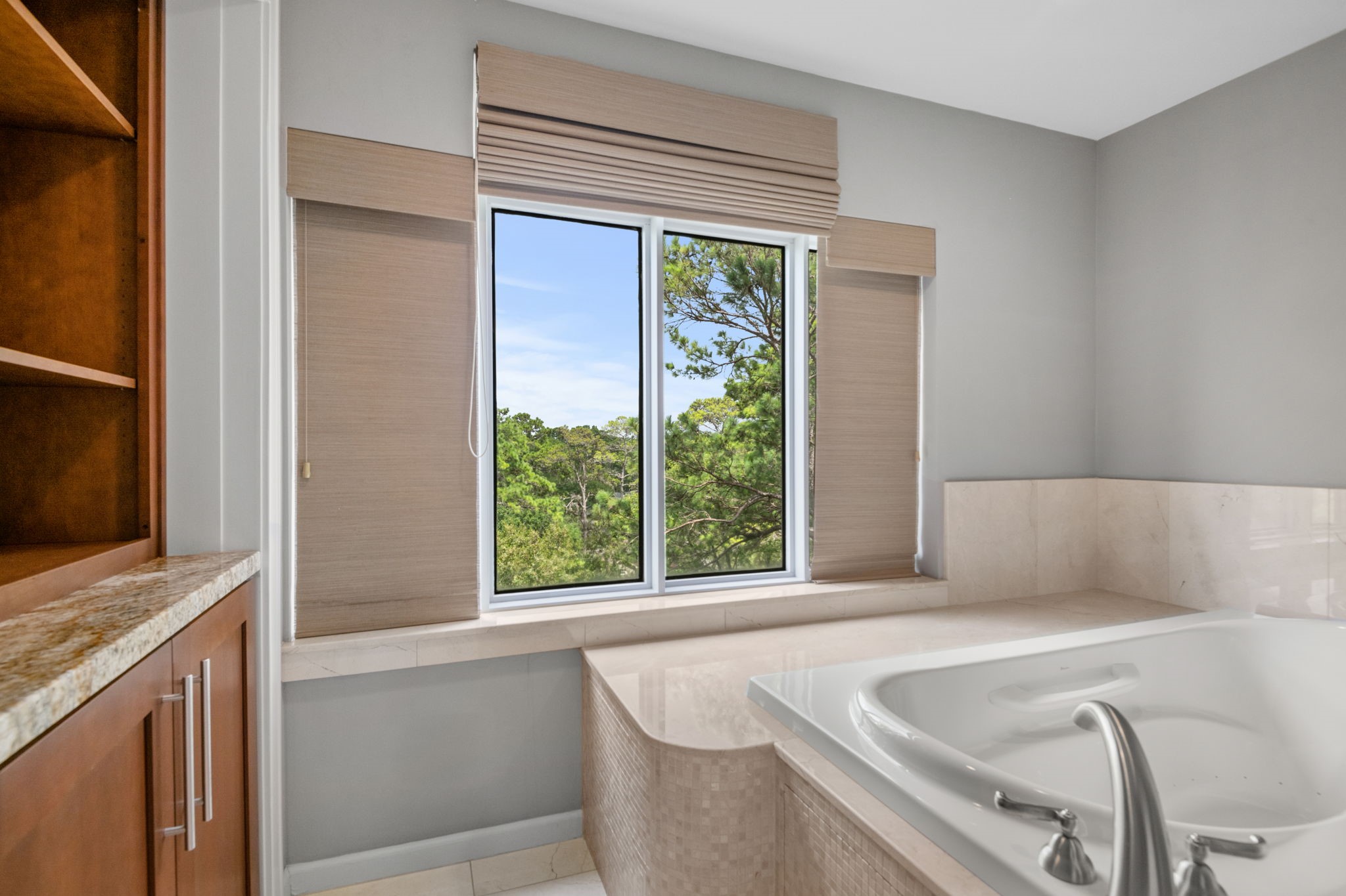 14x10 Primary Bathroom - 
Jetted tub with deck and a view. Built-in cabinetry for additional storage.