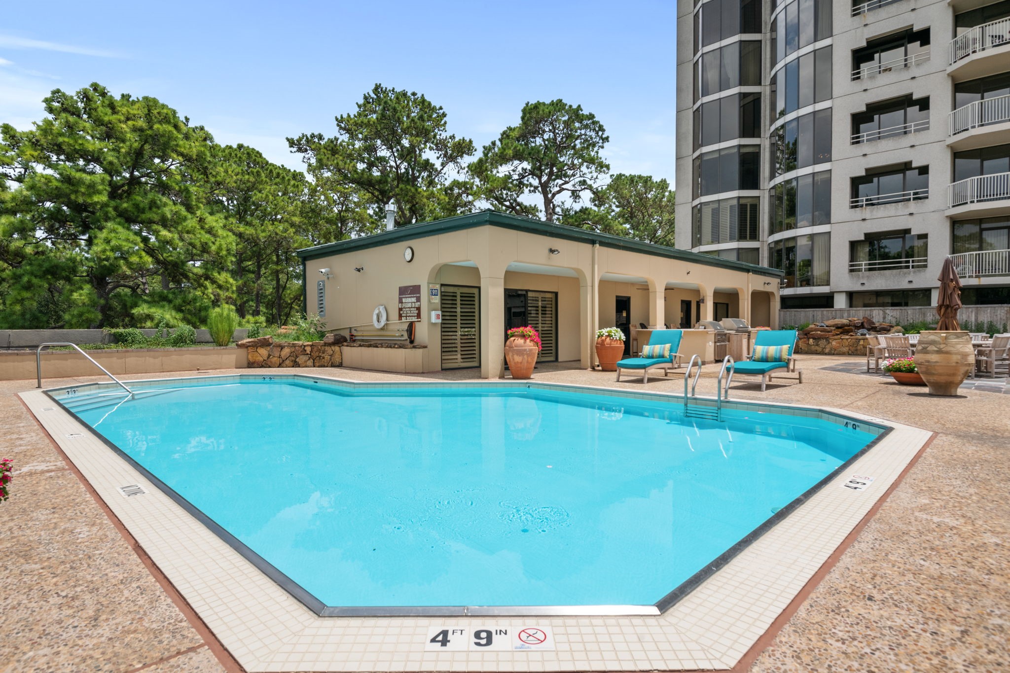 The Tealstone pool - 
Outdoor kitchen with 2 grilling areas is in the background.