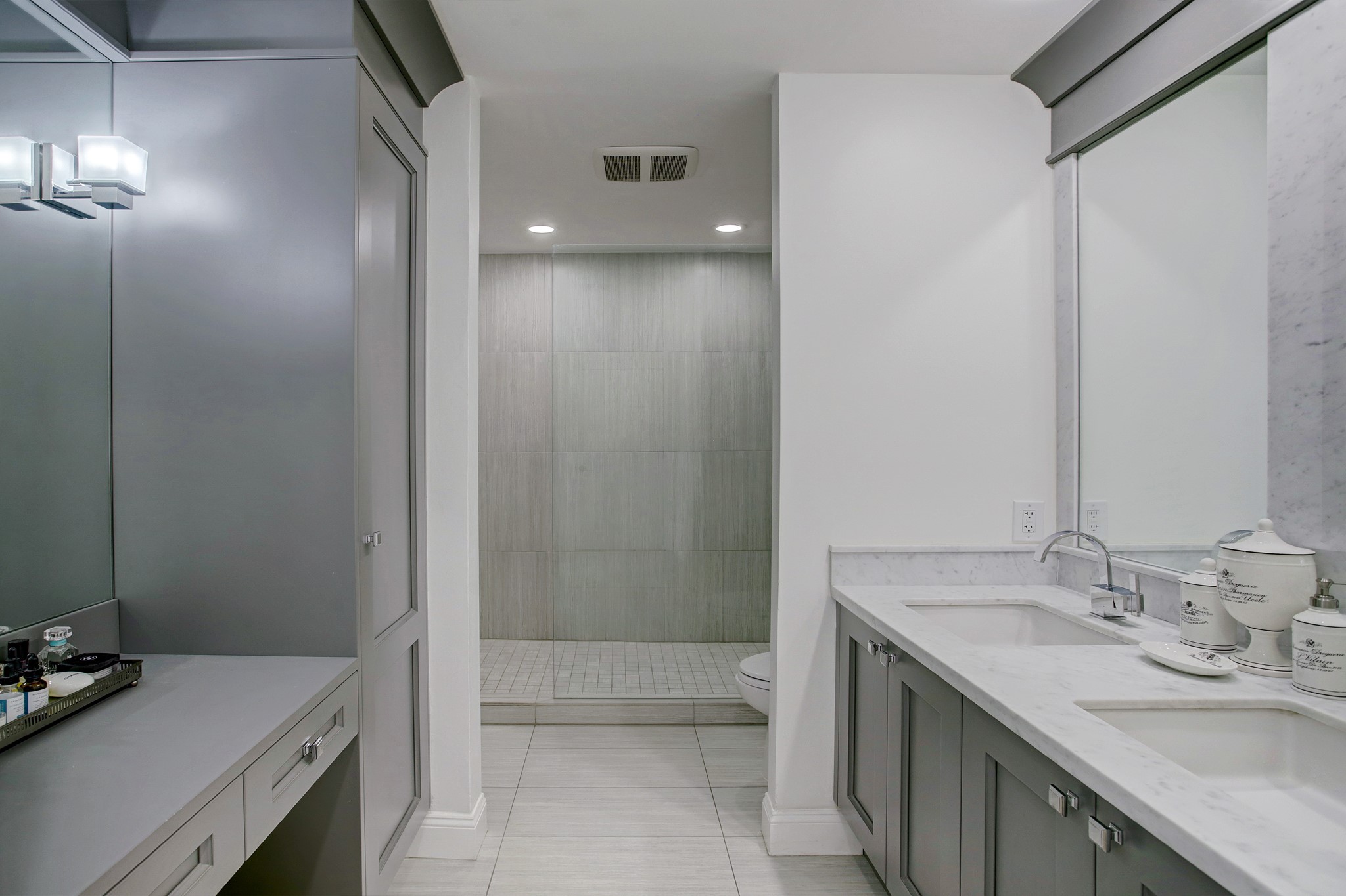 Beautiful primary bathroom with marble countertops and Downsview fine custom cabinetry