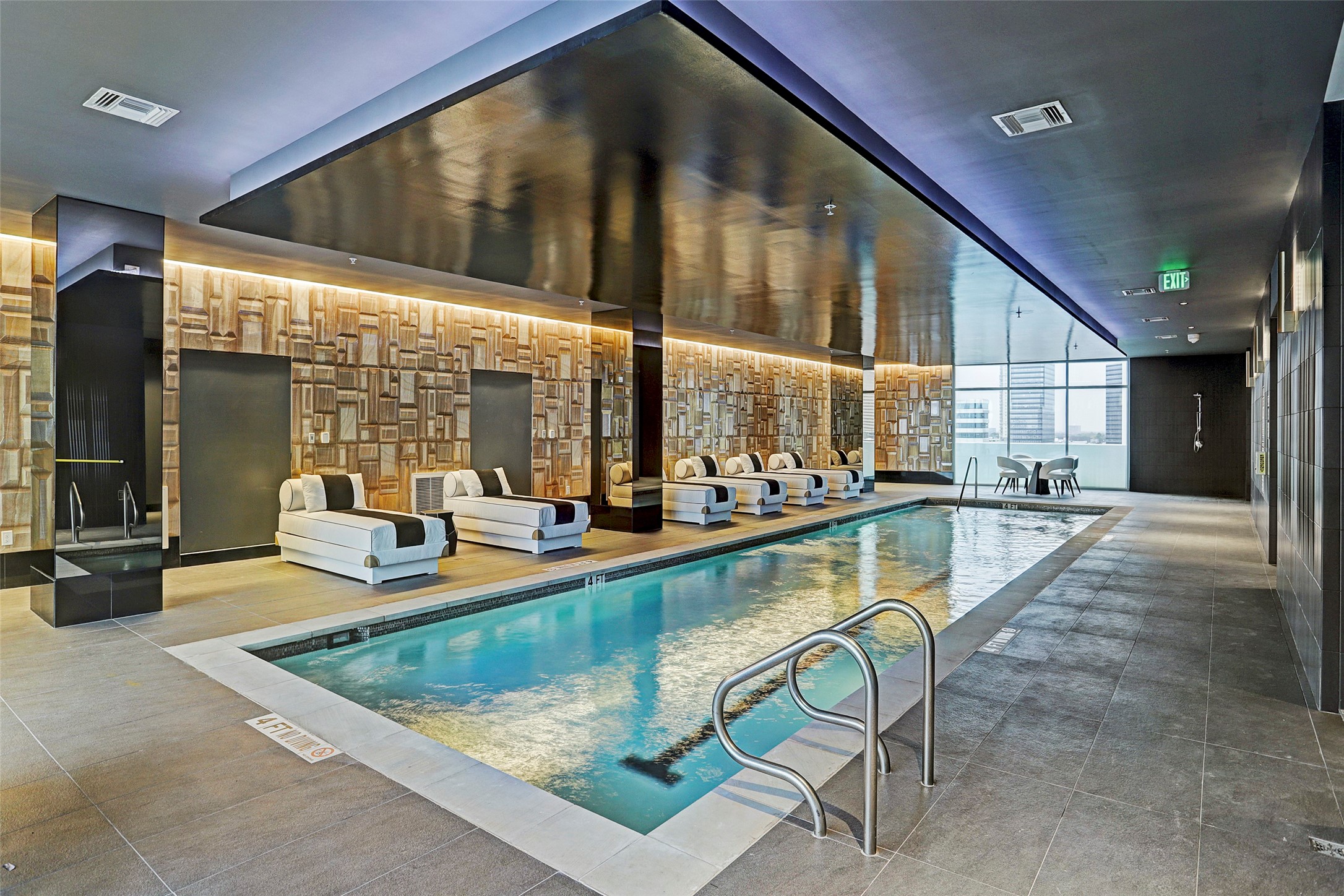 The spa-like indoor pool features walls of glass as well as immediate access to a sauna, massage room and pet salon