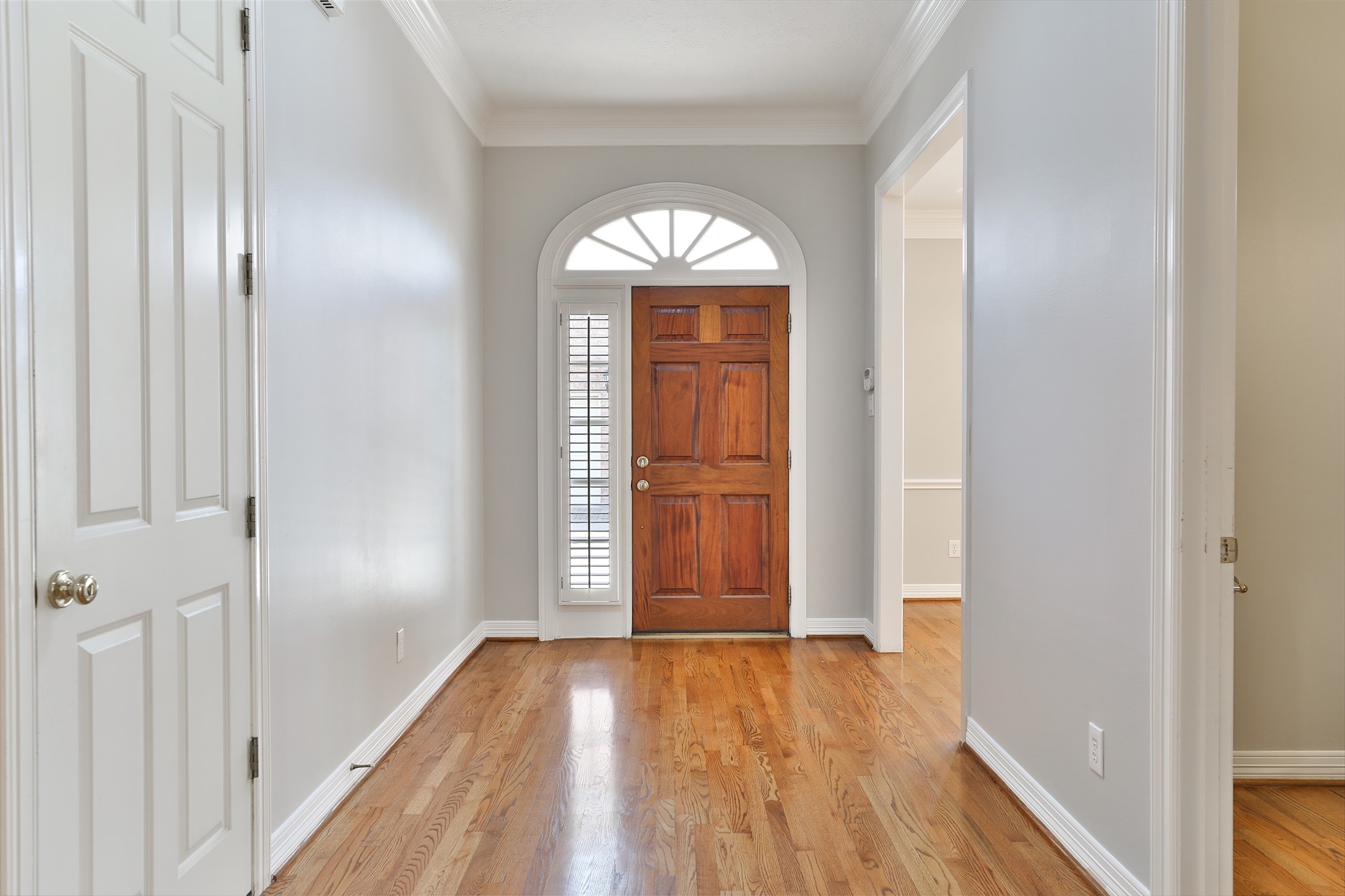 Natural wood floors span the downstairs space.