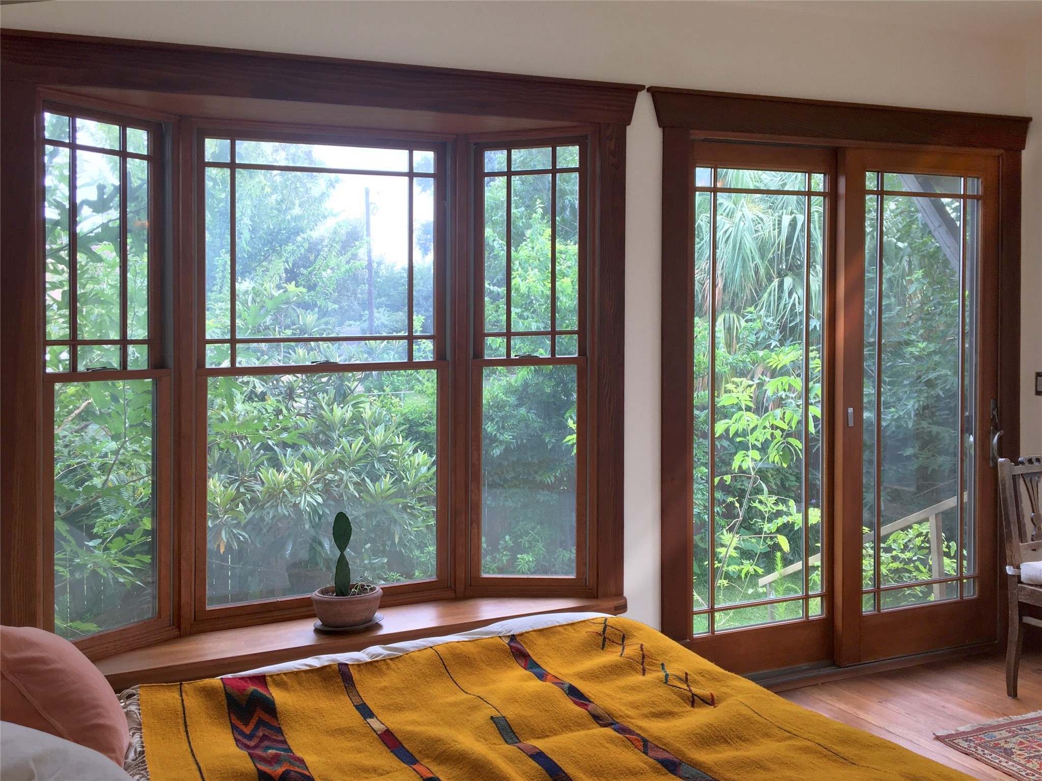 Prairie style bay windows and sliding-glass doors add light and views to the great room.