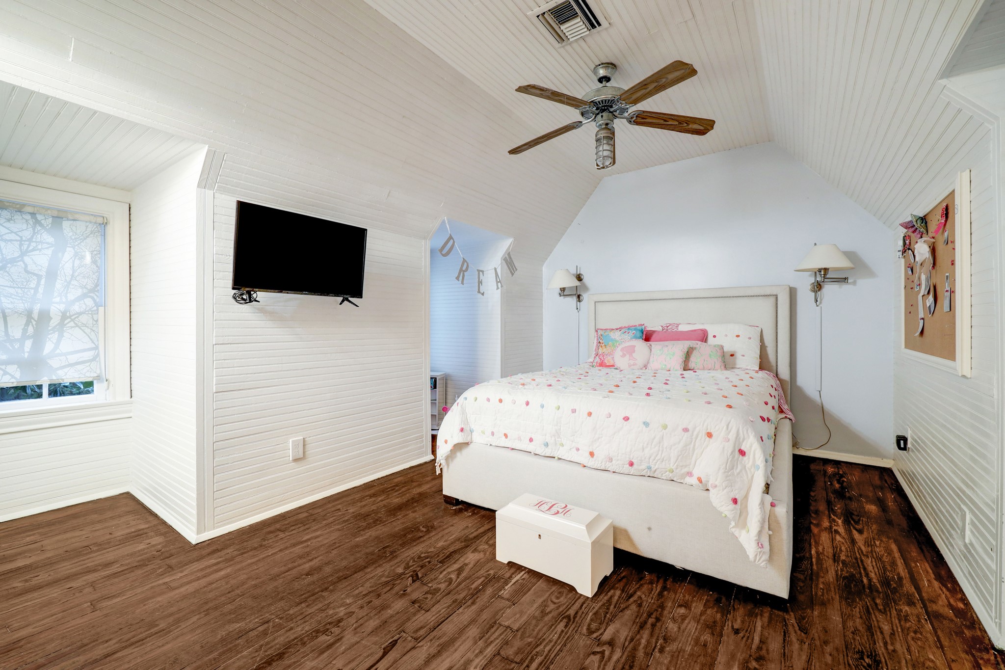 Cozy bedroom No. 2 is built under the eaves of the house and lined with beadboard.
