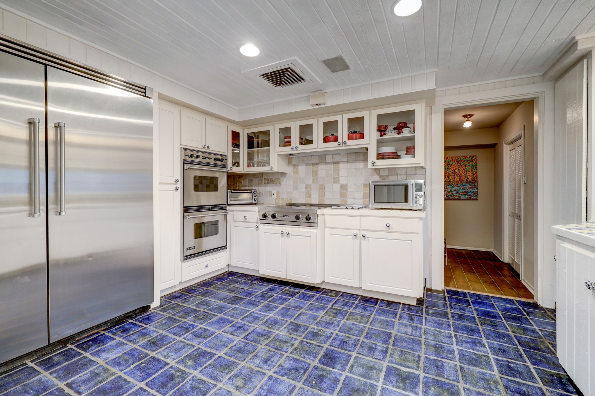 Another view of the kitchen with Viking side-by-side refrigerator, cook top and double wall ovens.