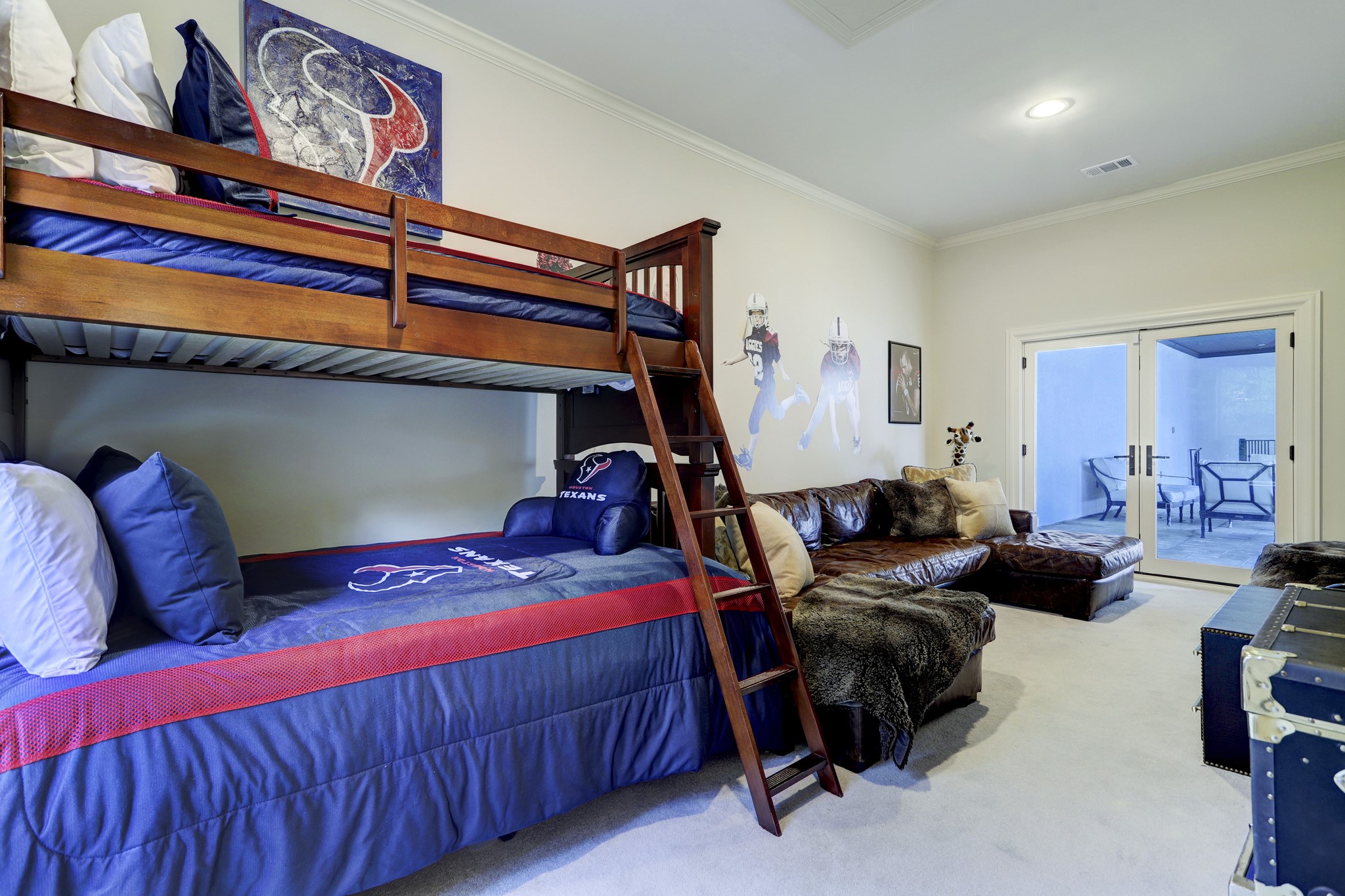 This fun bedroom is located off the back of the home on the second floor with access to the second floor patio overlooking the pool/spa and a seperate staircase leading to one of the garages - making it a ideal live in residence or extended family.