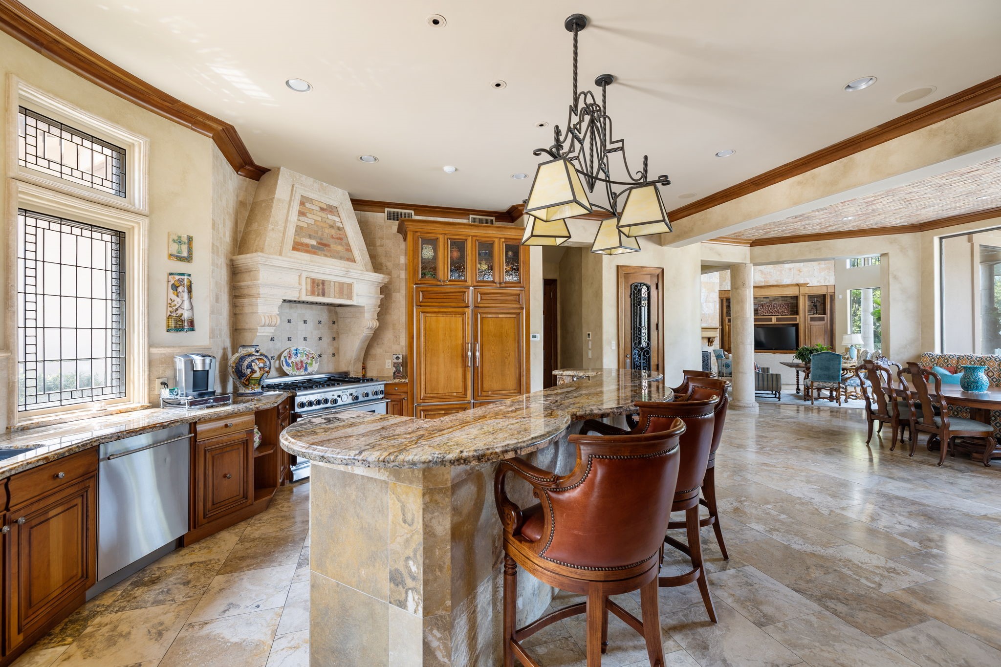This Connoisseur's Kitchen as well includes: granite countertops, Scotsman ice machine and Subzero beverage refrigerator. The Island accommodates counter-height seating for four. Also included within is a 600-bottle climate controlled walk-in wine room with custom iron door.