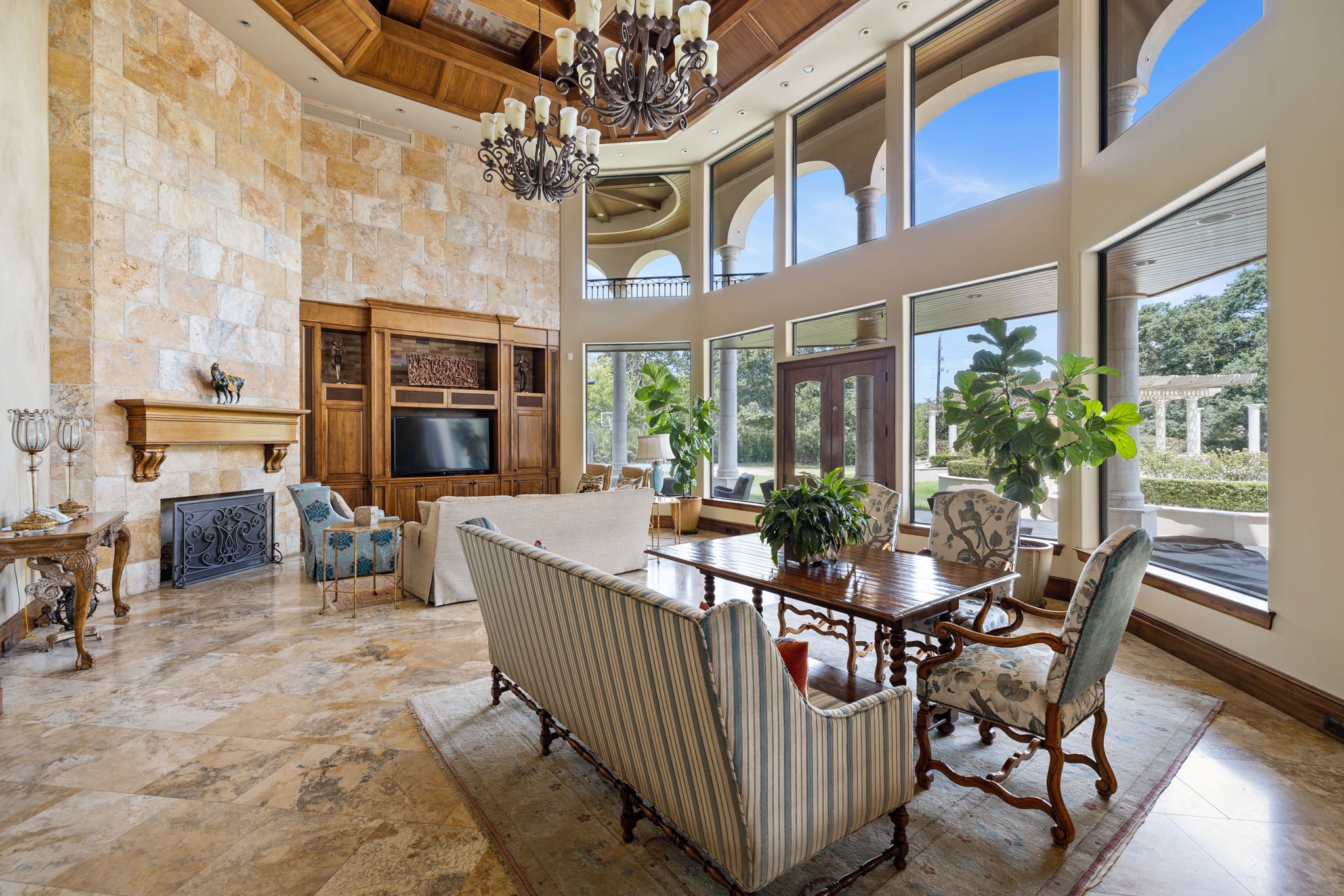Now that we have been well fed, let us retreat to the Great Room with its tumbled stone accent wall and a gas log Fireplace accentuated with a stately mantle, entertainment center and rustic stonework.