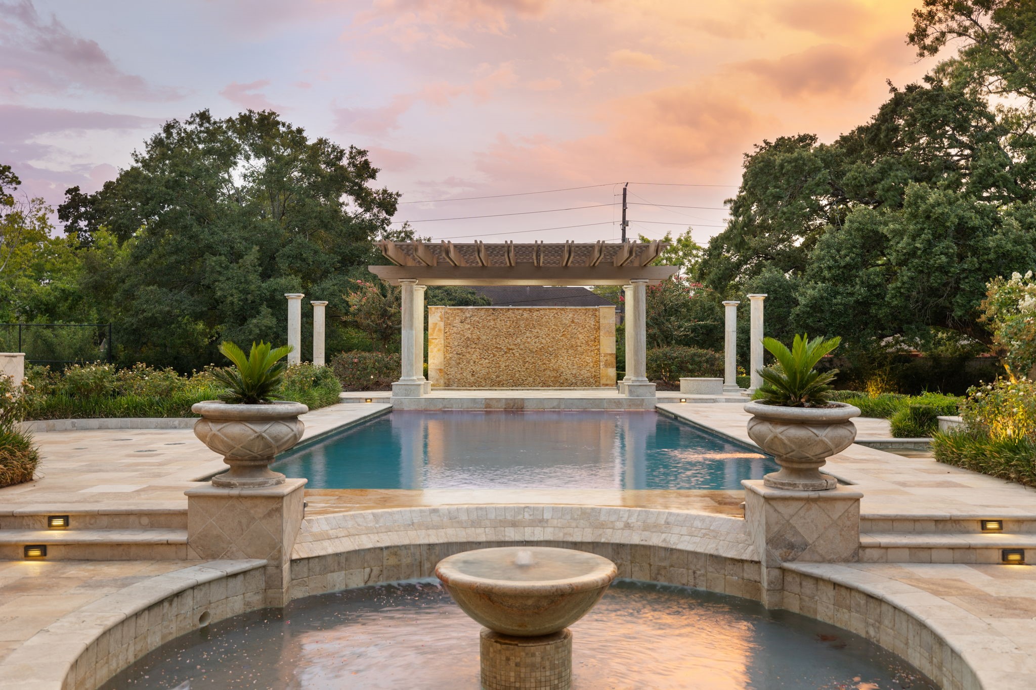 The Back Yard is rich with water as sculpture. Here a bubbling fountain within a waveless basin draw your eye towards the heated swimming pool and stone framed wall of water.