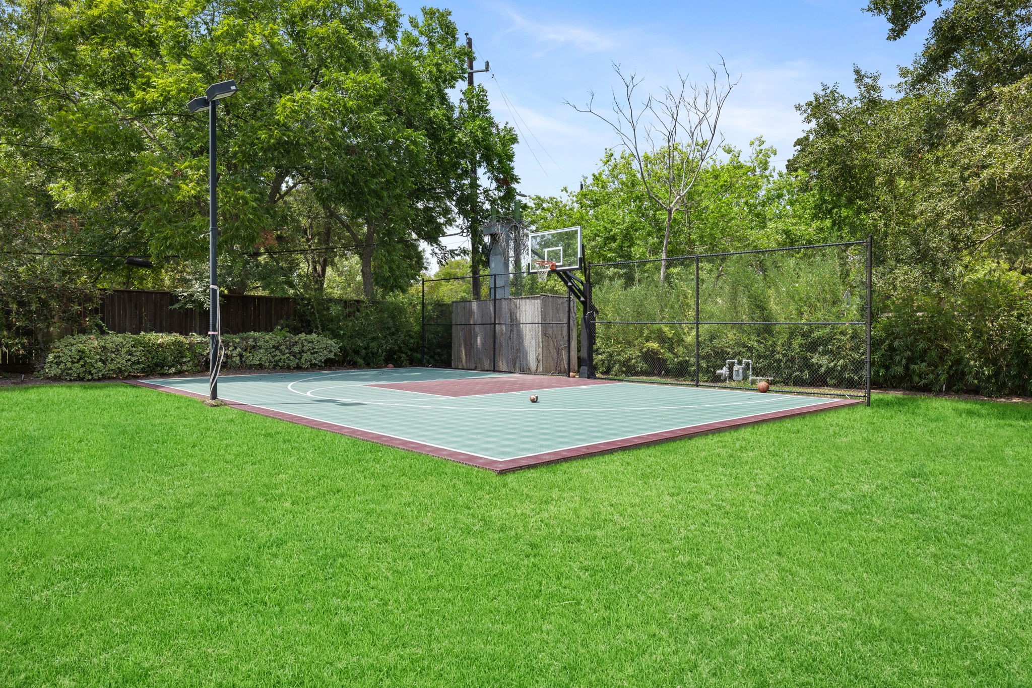 The lighted Sports Court is tucked away on the northwest corner of the Estate. Practice your Golf or Tennis swing, smack the Tetherball around the pole, put together a pick up game of Basketball, or be all the rage and convert the Sports Court to a Pickleball Court!