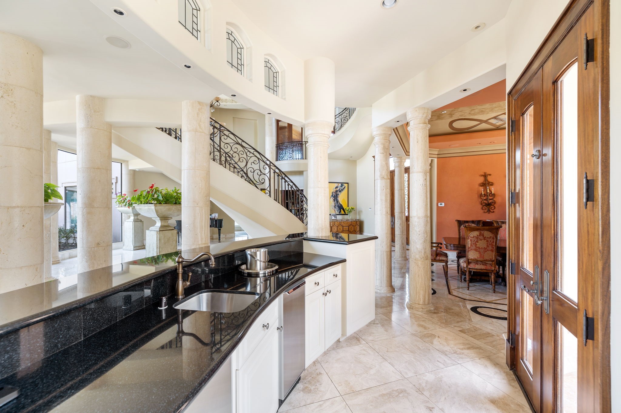 Off another axis of the Grand Entry is a Wet Bar between the Living Room and the Dining Room.  Above are more leaded glass clerestory window, while the Bar itself is topped with granite countertops, equipped with an Scotsman ice machine and Subzero beverage refrigerator.
