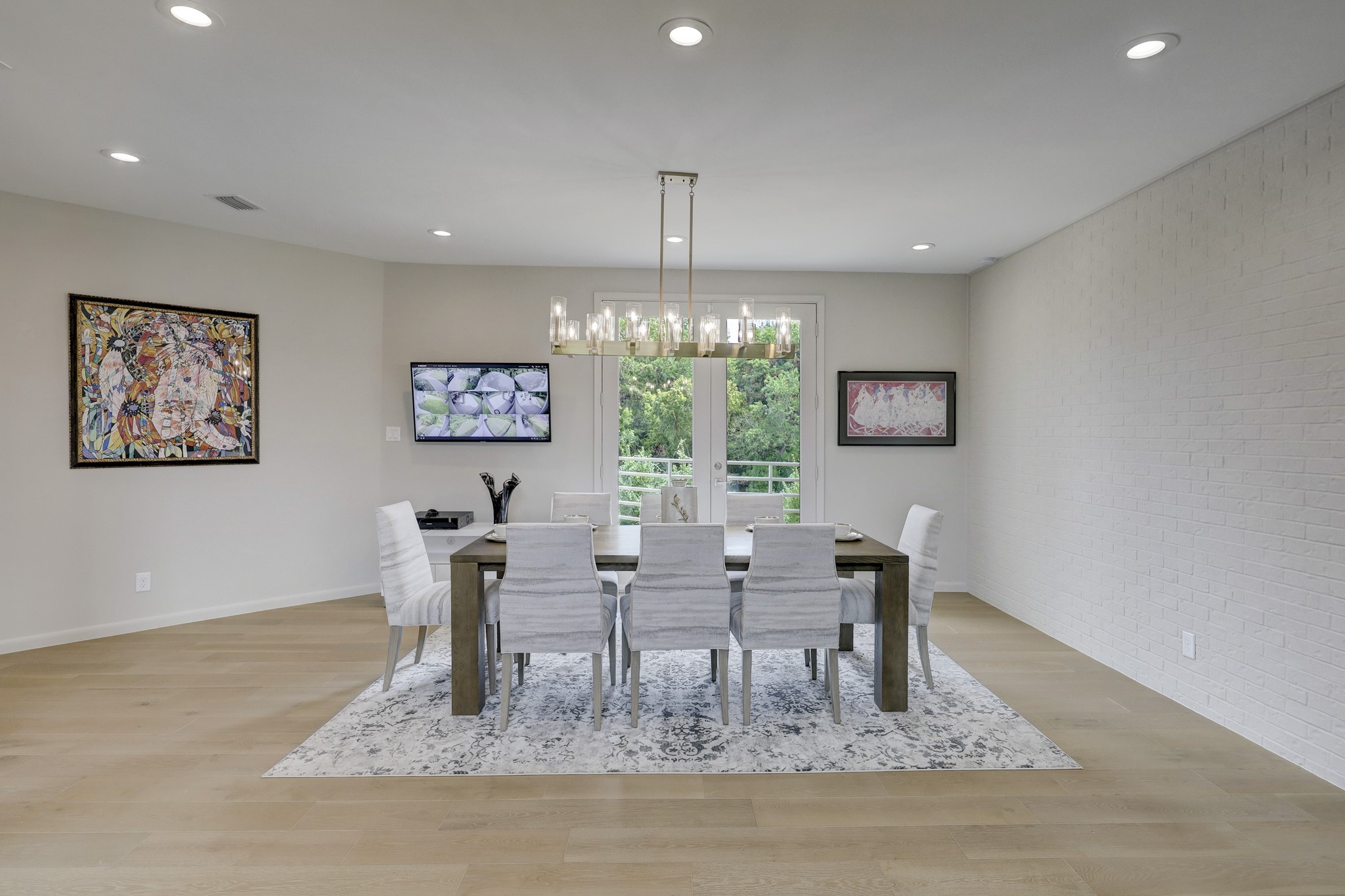 The second floor Formal Dining Room features custom chandelier, recessed LED lights, and opens to the second floor balcony.