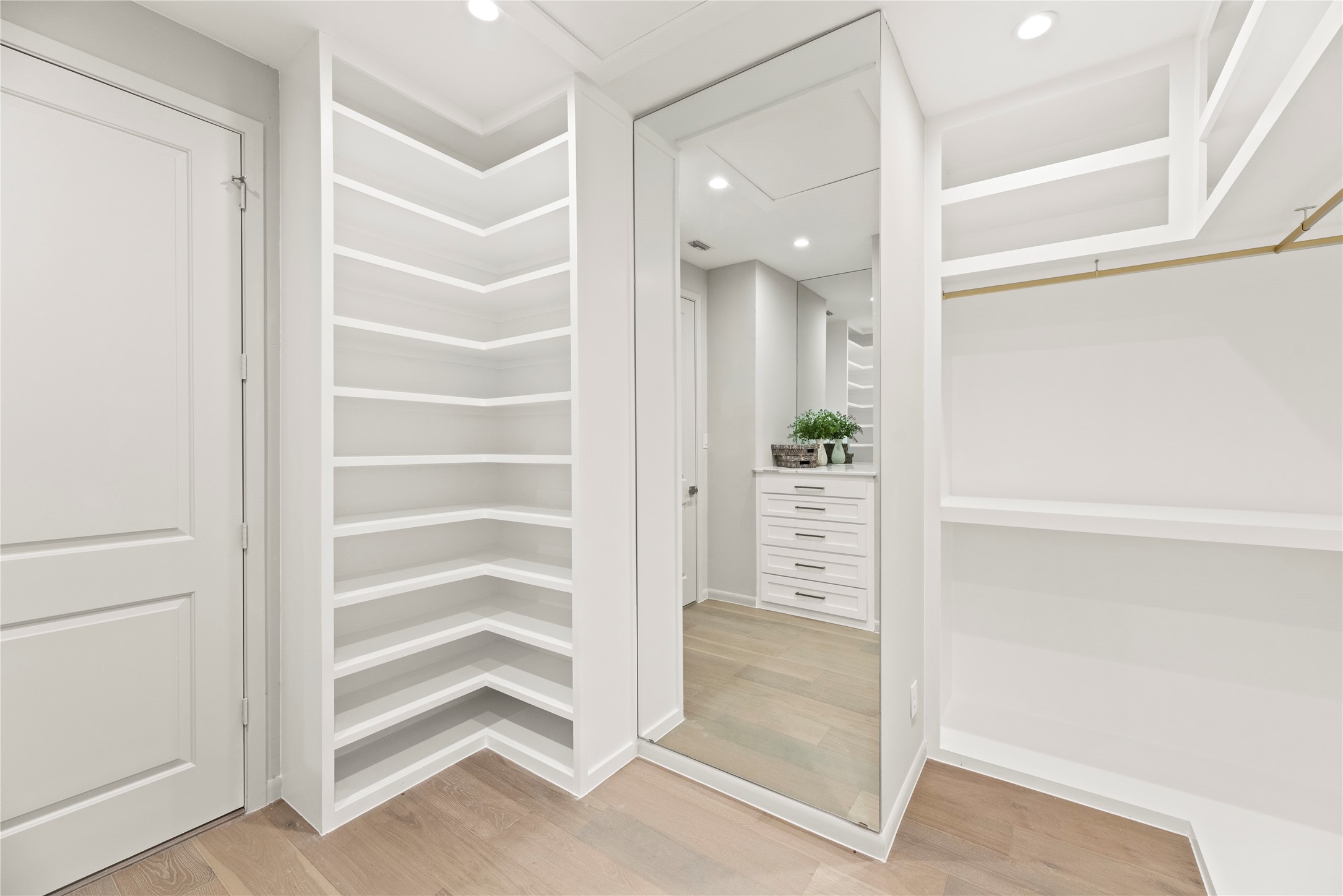 One of the 2 walk-in closets with built-ins in the primary suite. [There are TWO large walk-in closets + a secret closet, + CEDAR closet off the primary bdrm. (Not shown.)
