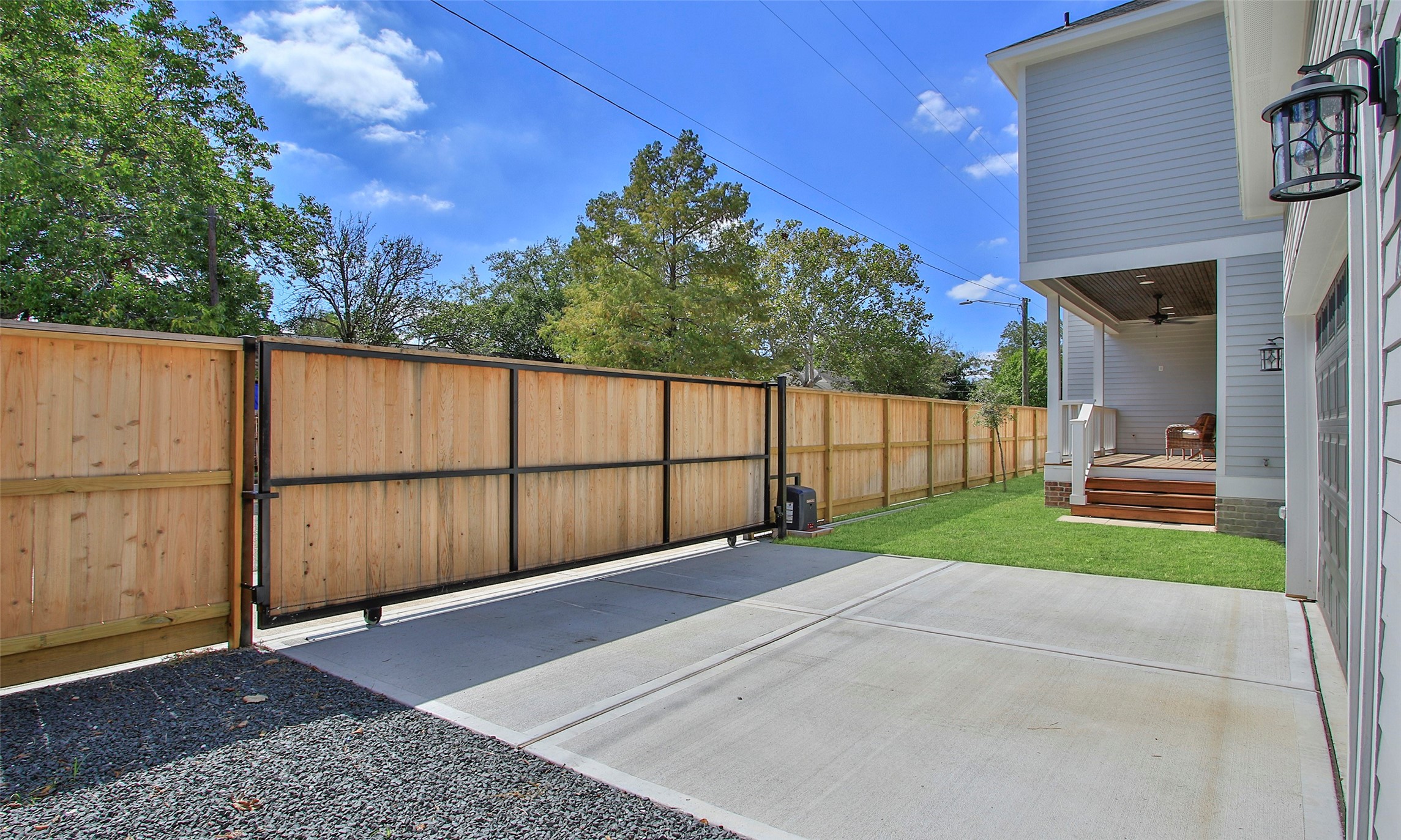 Privacy fence with rolling gate and automatic gate opener