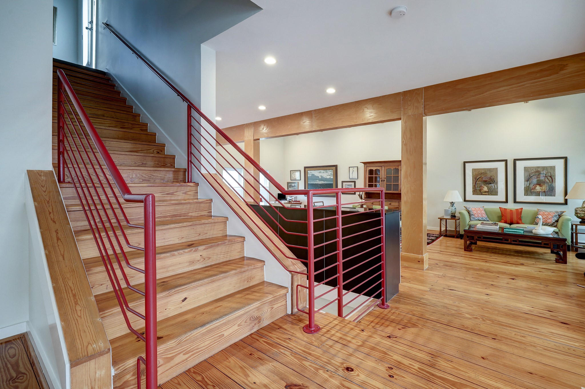 This staircase leads to the serene their floor primary bedroom suite.