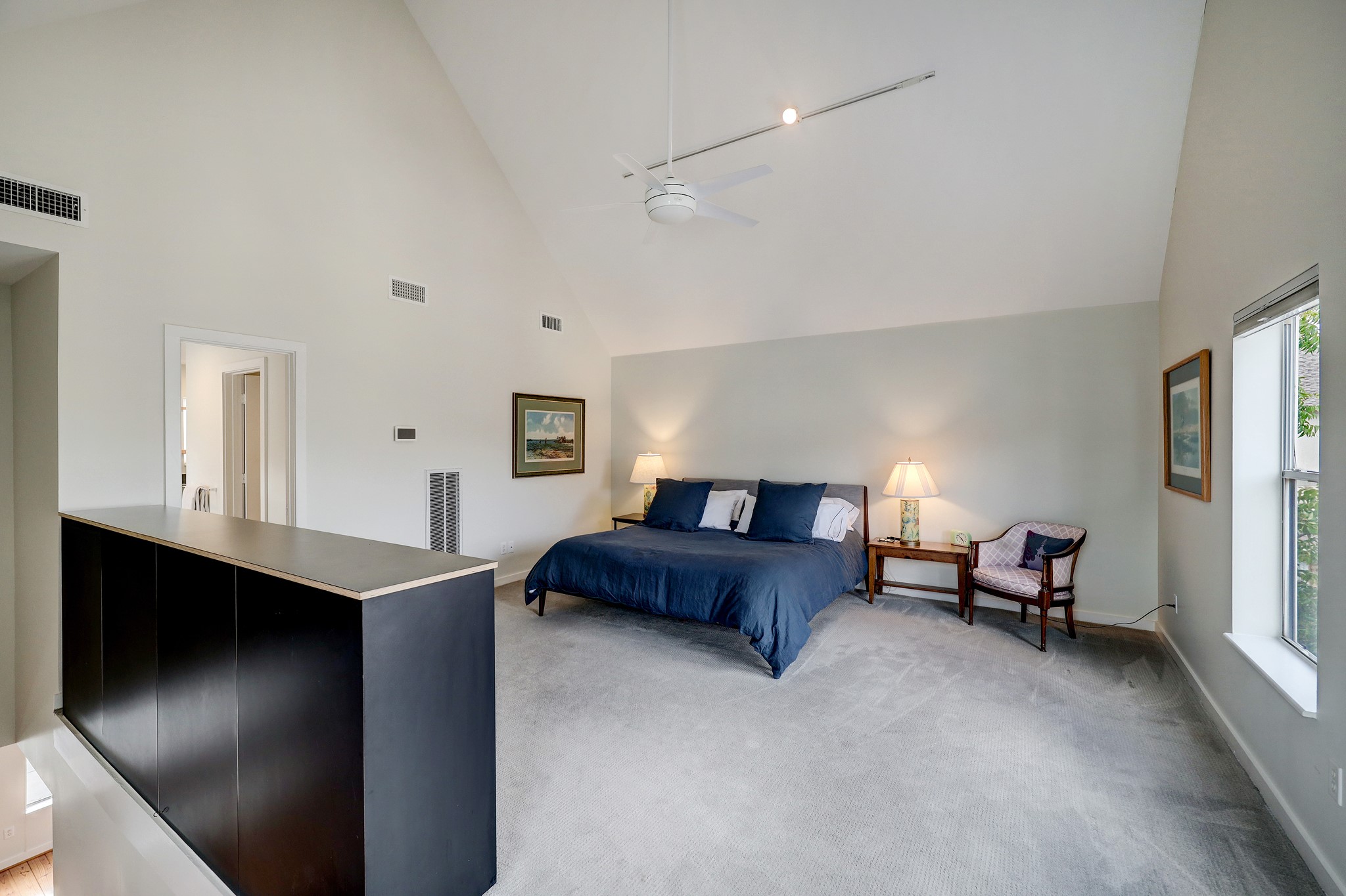 The third floor primary suite enjoys vaulted ceilings and natural light.