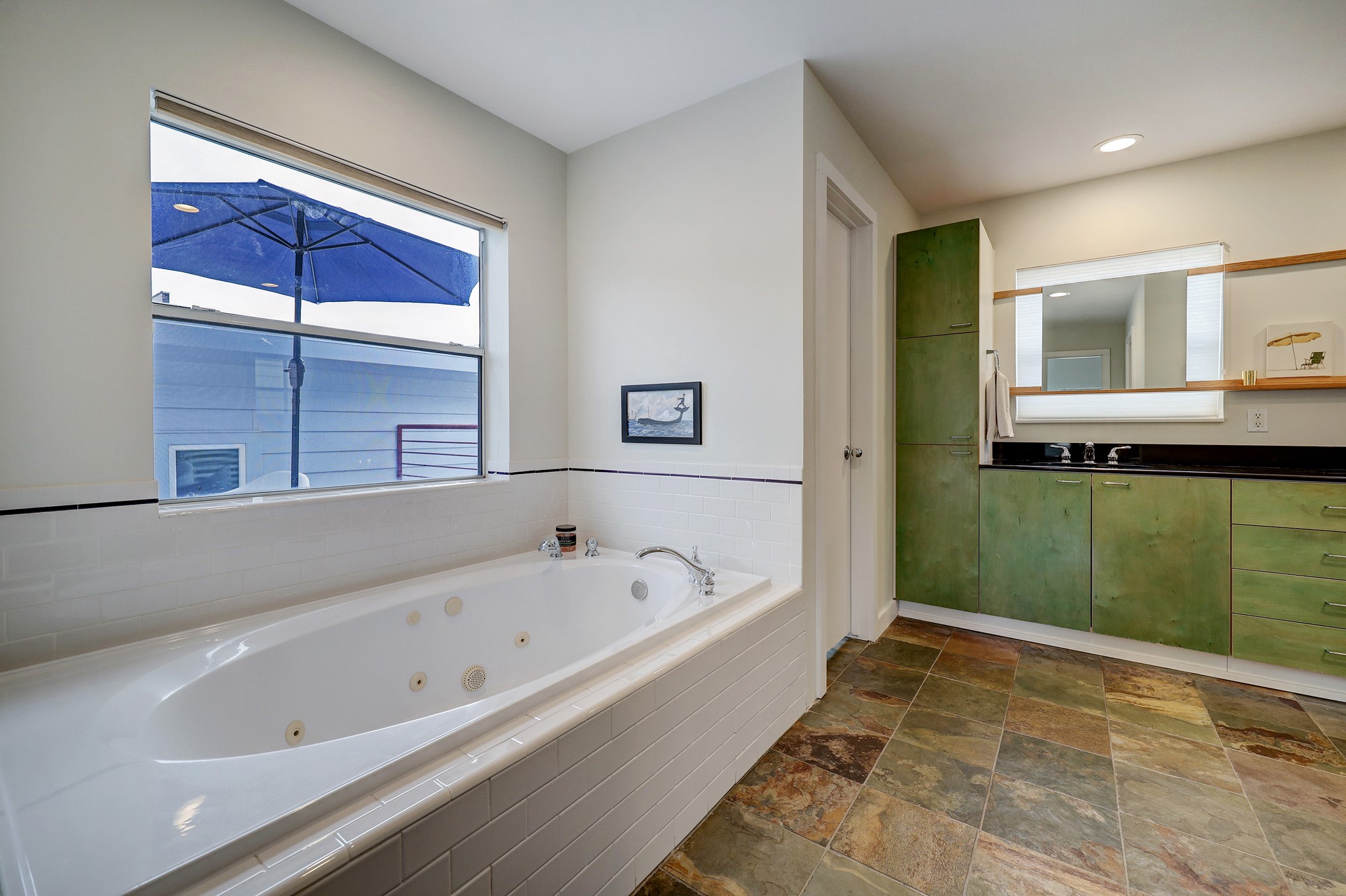 The generously sized primary bath also  has a jetted spa tub.