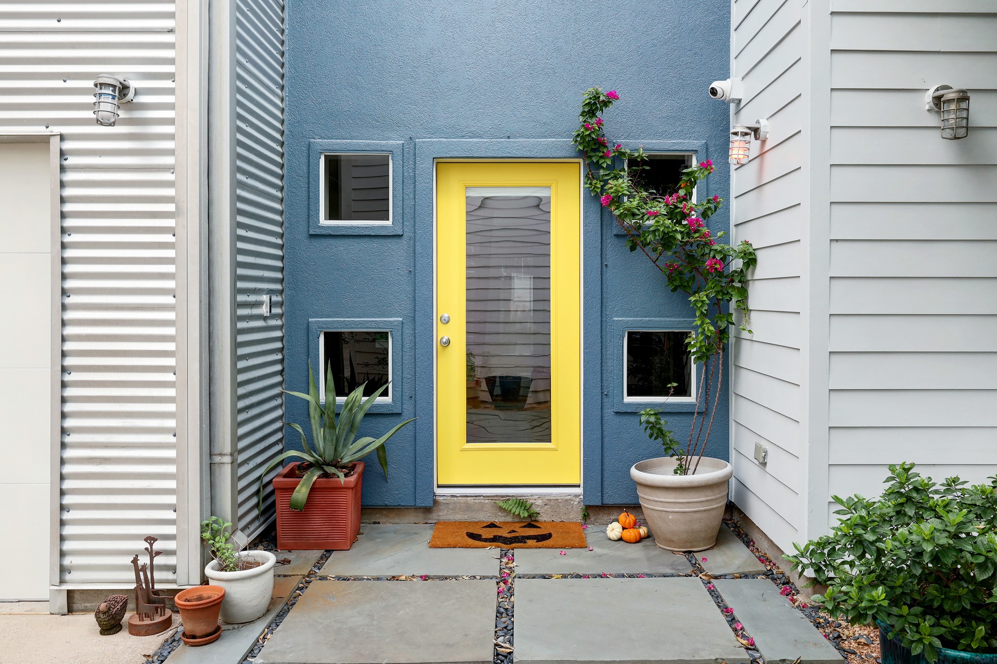 I love this entry with fun color scheme, camera system that stays with home and pretty stone patio area. Stucco recently sealed with premium Elastomeric paint.