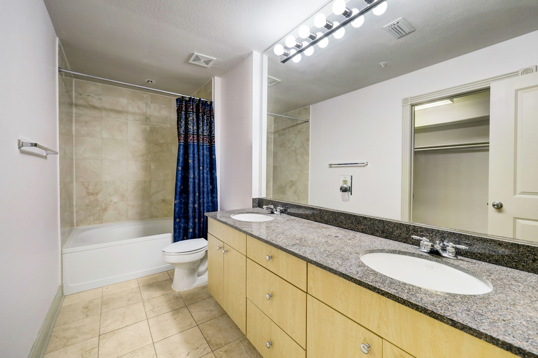 Primary Bath - with double undermount sinks, Hollywood vanity lights, spacious cabinetry storage and with direct access to primary walk-in closet