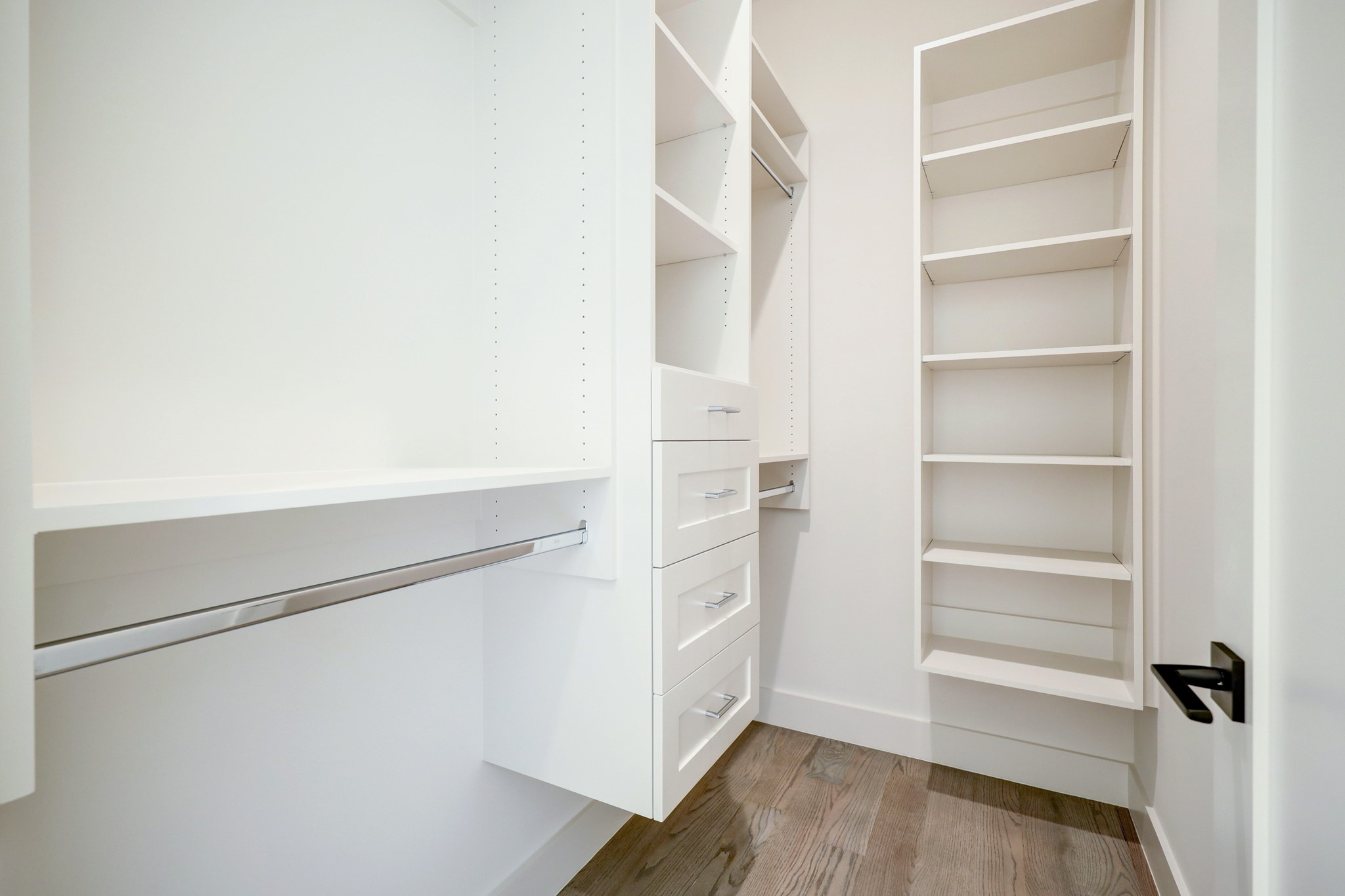 An example of a secondary closet showing built-in drawers, adjustable shelving and hanging.