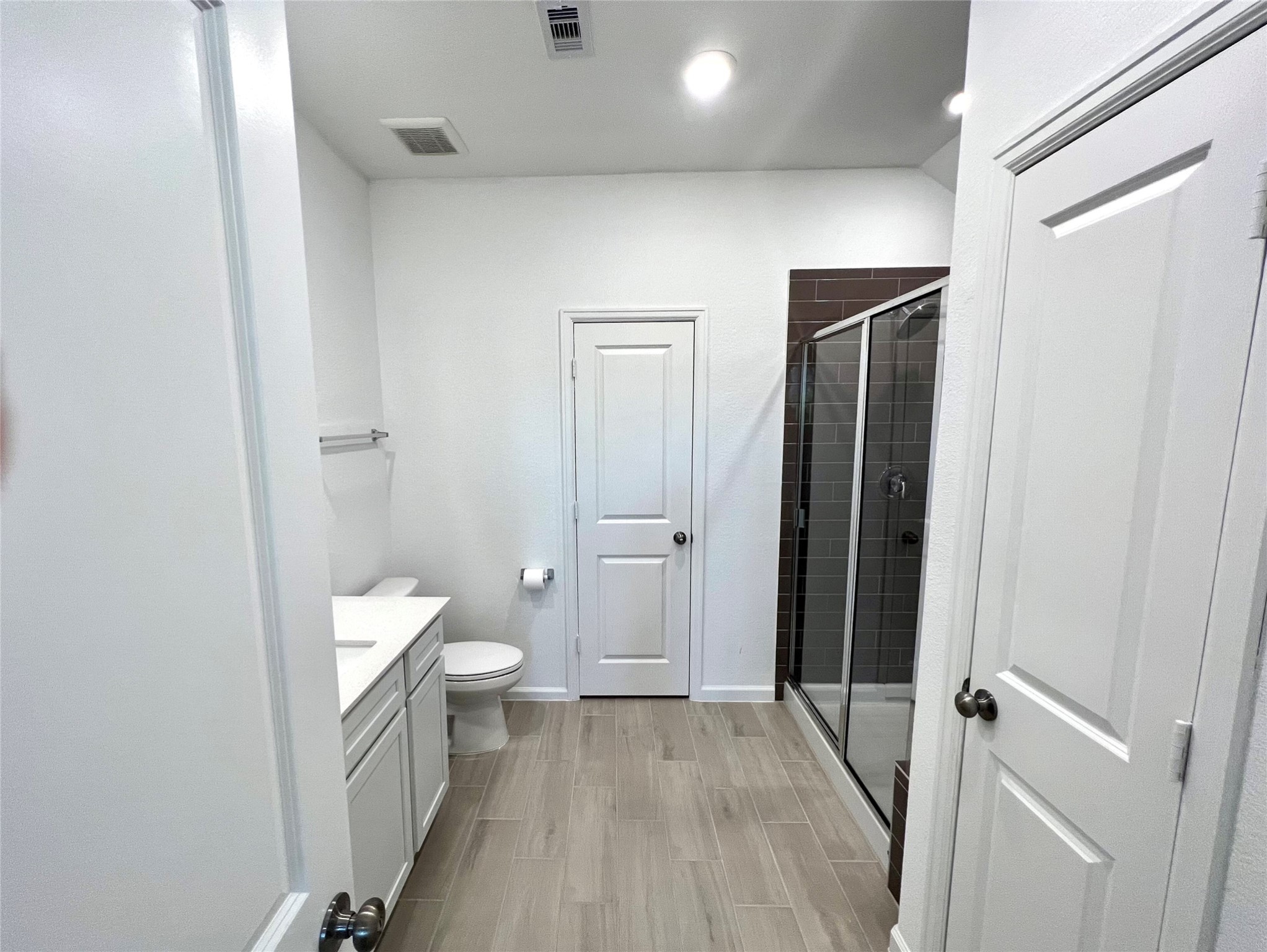 Secondary bathroom with huge walk-in shower & sleek modern finishes.