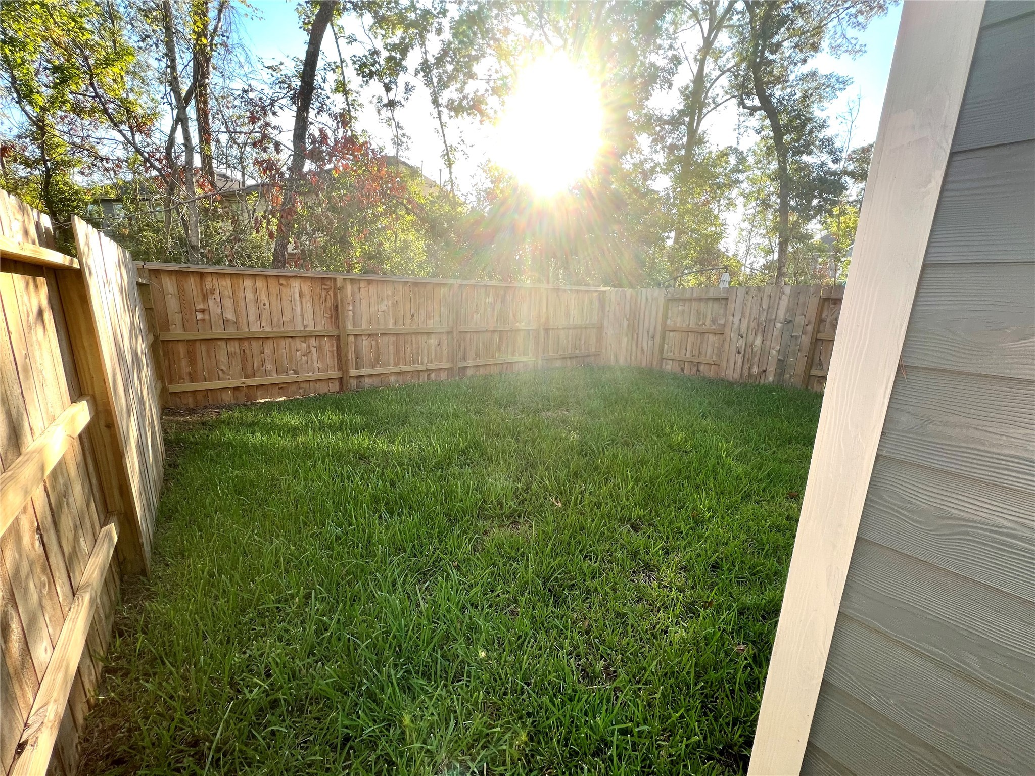 Backyard is spacious and fenced.