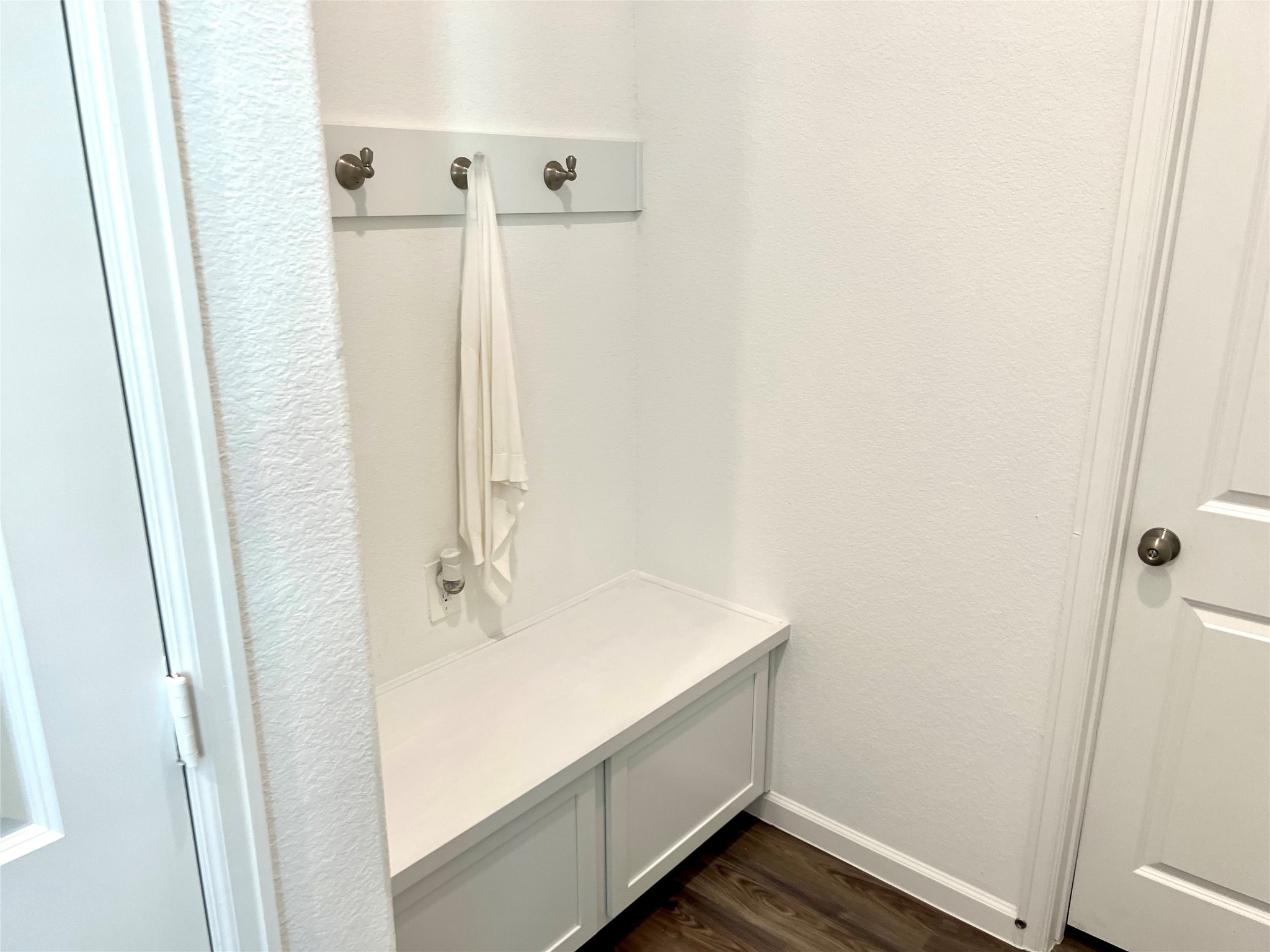 Off the garage entry is a convenient drop zone, plus a half bath with an attached storage closet.