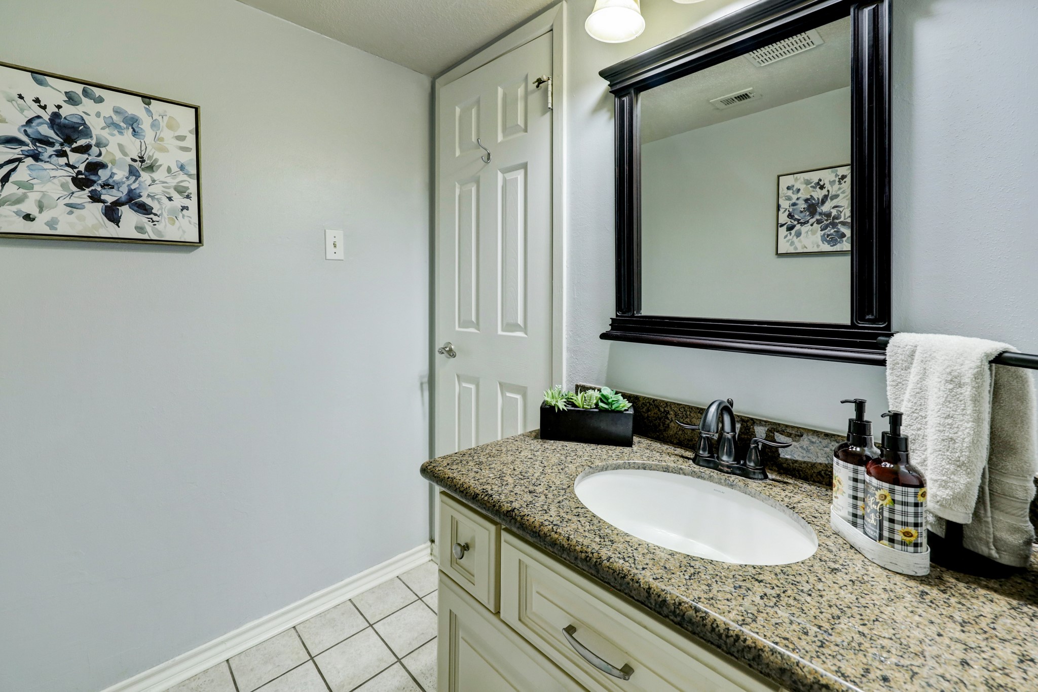 Conveniently located between the kitchen and the dining room is the half bathroom.