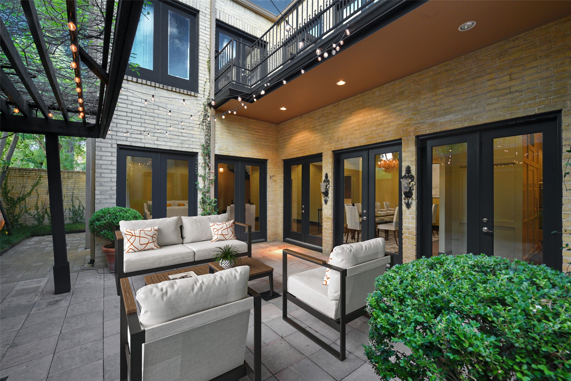 The easy access in and out of the home to the courtyard allows guests to mingle effortlessly. The second floor balcony overlooks the courtyard.