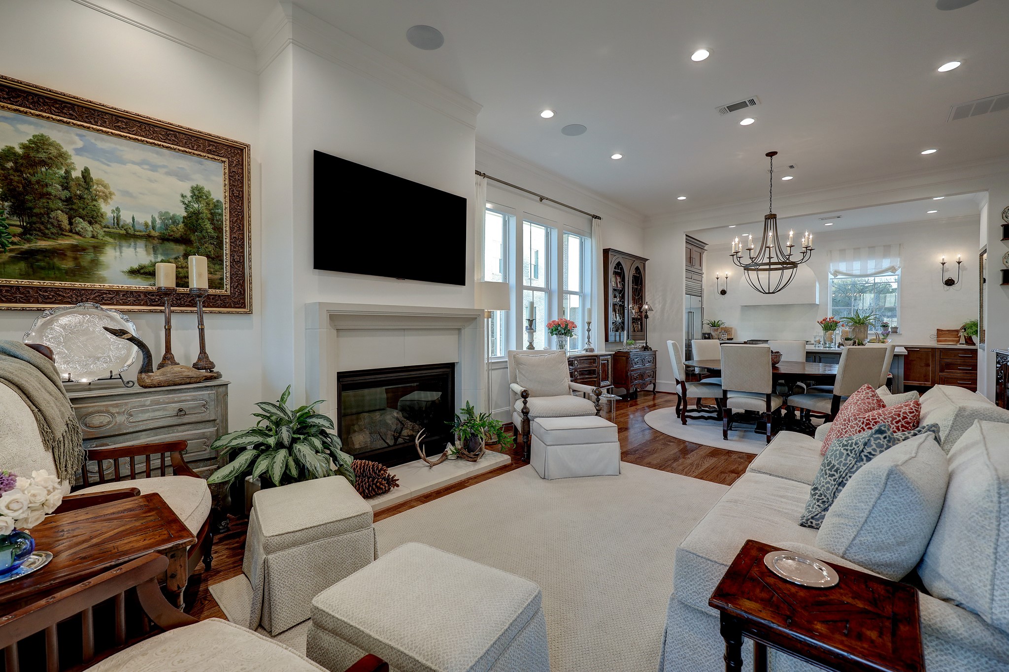 Relax with your loved ones or entertain guests in your spacious living room boasting an elegant limestone gas log fireplace with extra wide hearth, recessed lighting, refined French doors to your private veranda, a TV mount, and art light.
