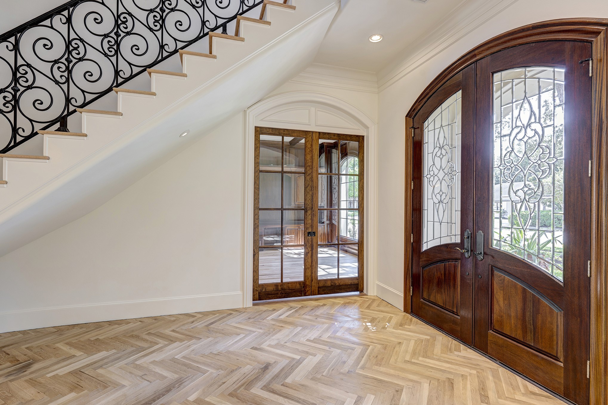 Open and bright entry welcomes your guests. Stunning custom Herringbone pattern floor. The floors have been recently refinished and are awaiting the new buyers choice of stain color.