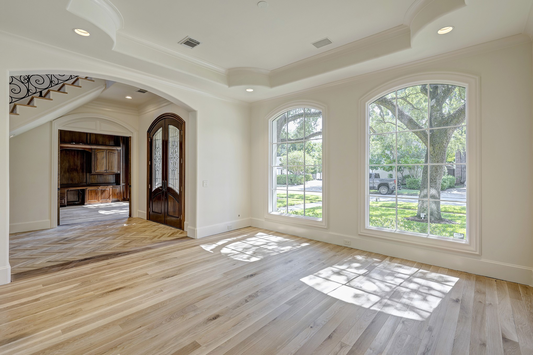 Formal dining room directly off the entry features wood floors, high ceiling and large windows.