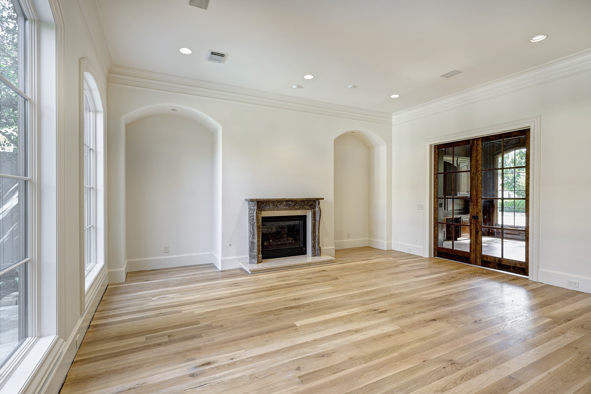 Formal living room is large and bright with gas log fireplace.