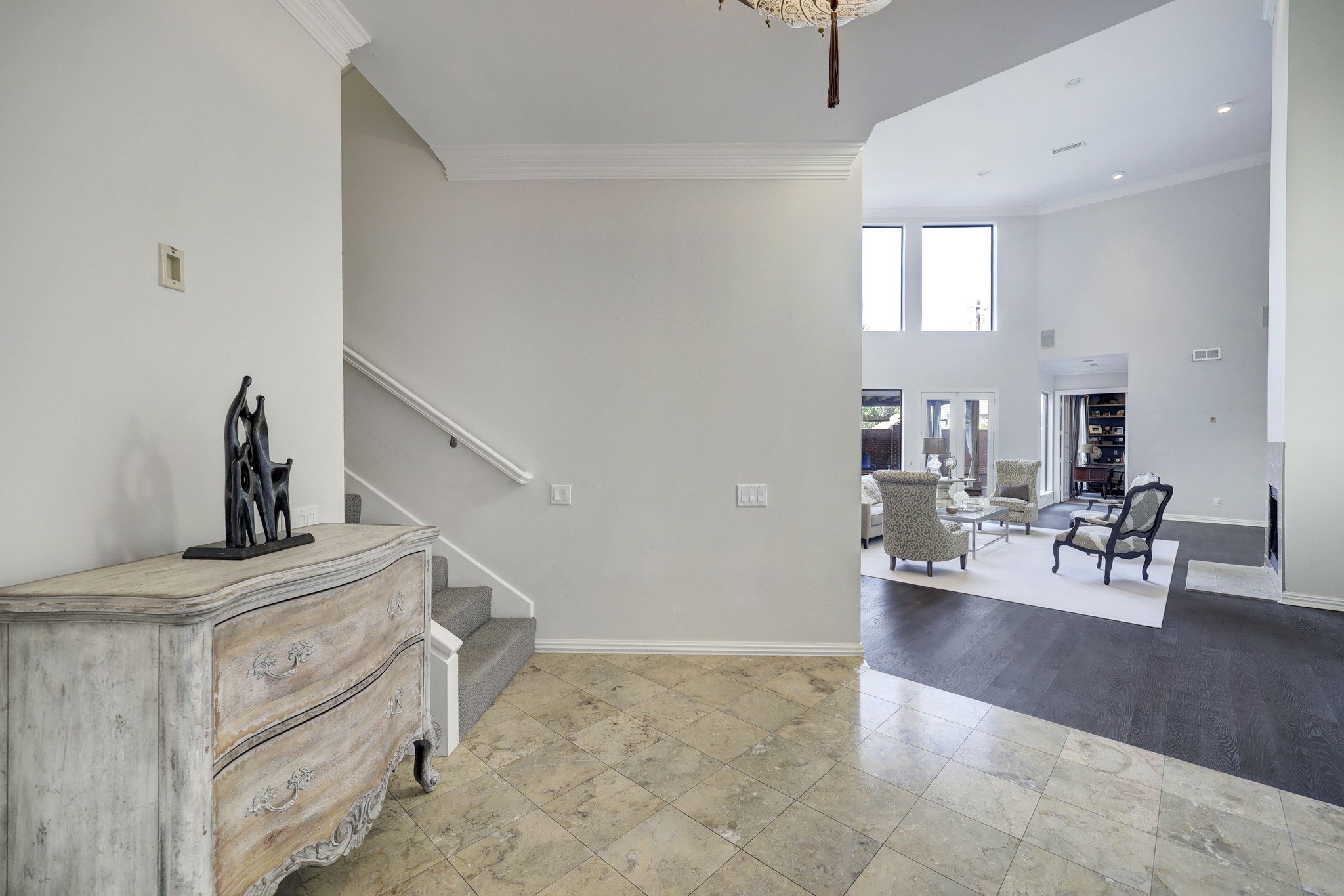 When you step into the formal foyer, you are greeted with an abundance of natural lighting from the living area.