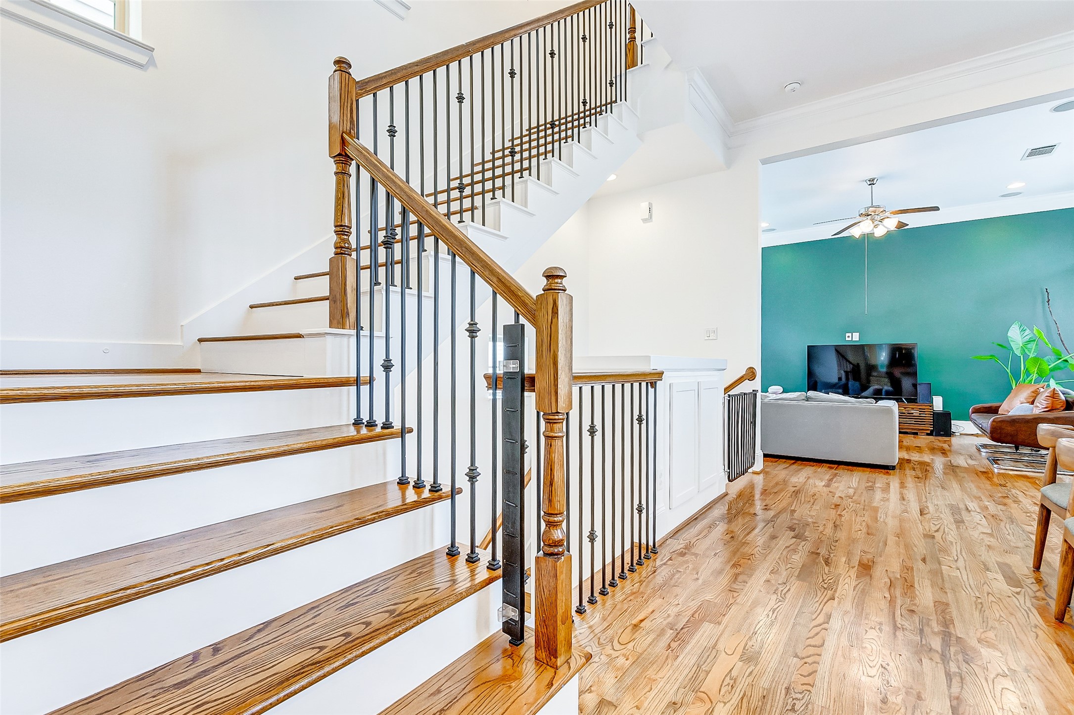 Easily access the Primary Ensuite, secondary bedroom, and utility room from the kitchen, dining room, and living room by climbing the beautiful iron spindled staircase to the third floor.