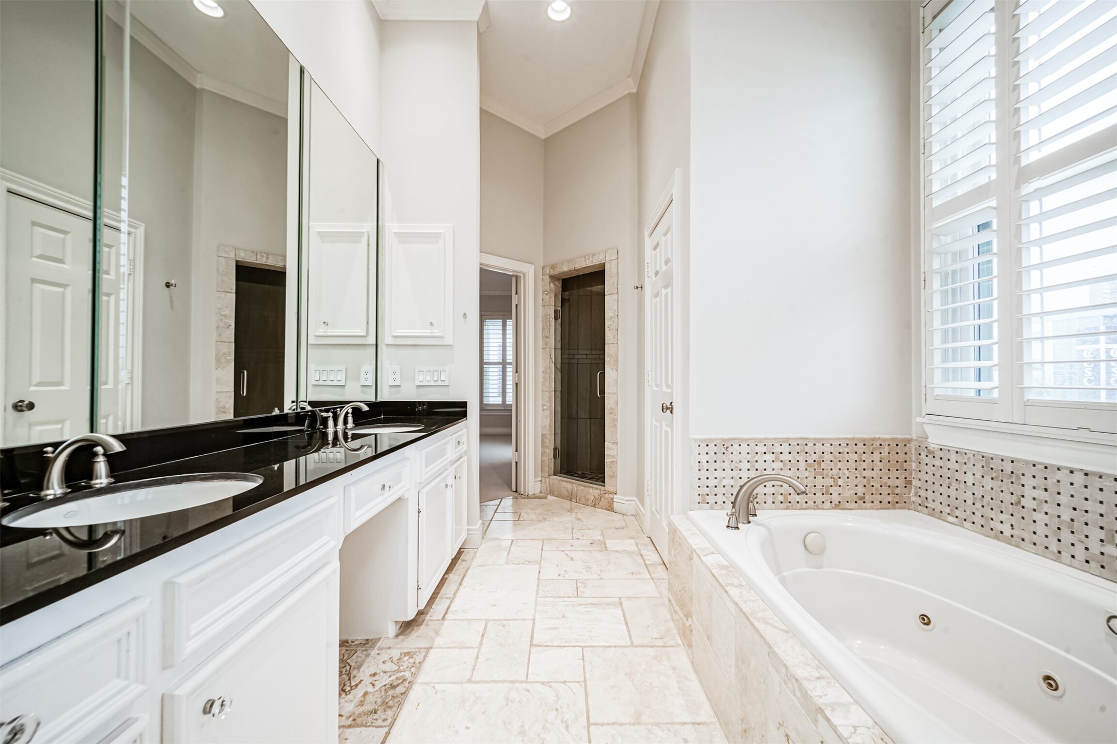 Luxurious Primary bath with double sinks, built in vanity area, large jetted tub, separate shower and water closet.