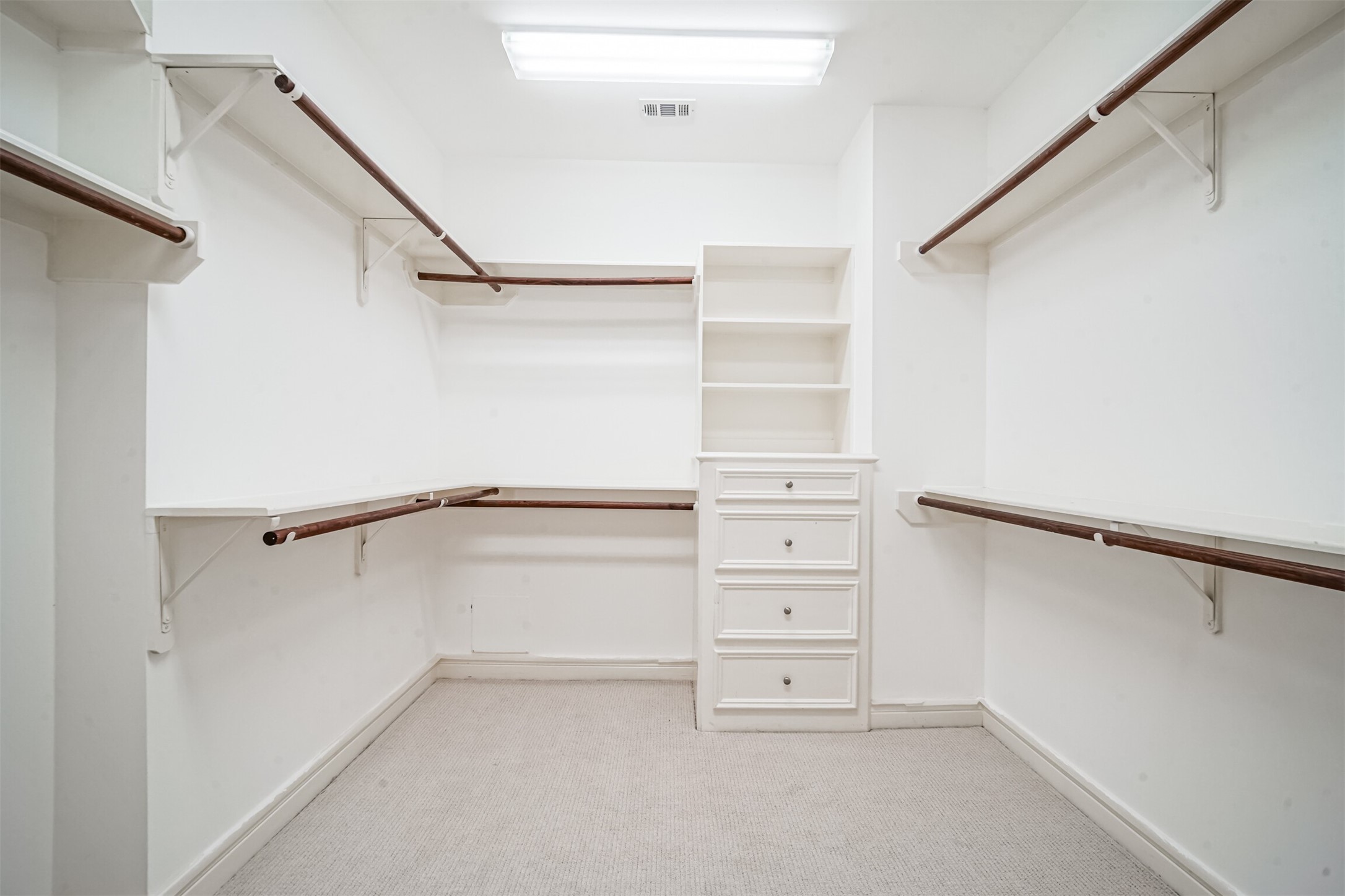 One of the two HUGE primary walk in closets with built ins.