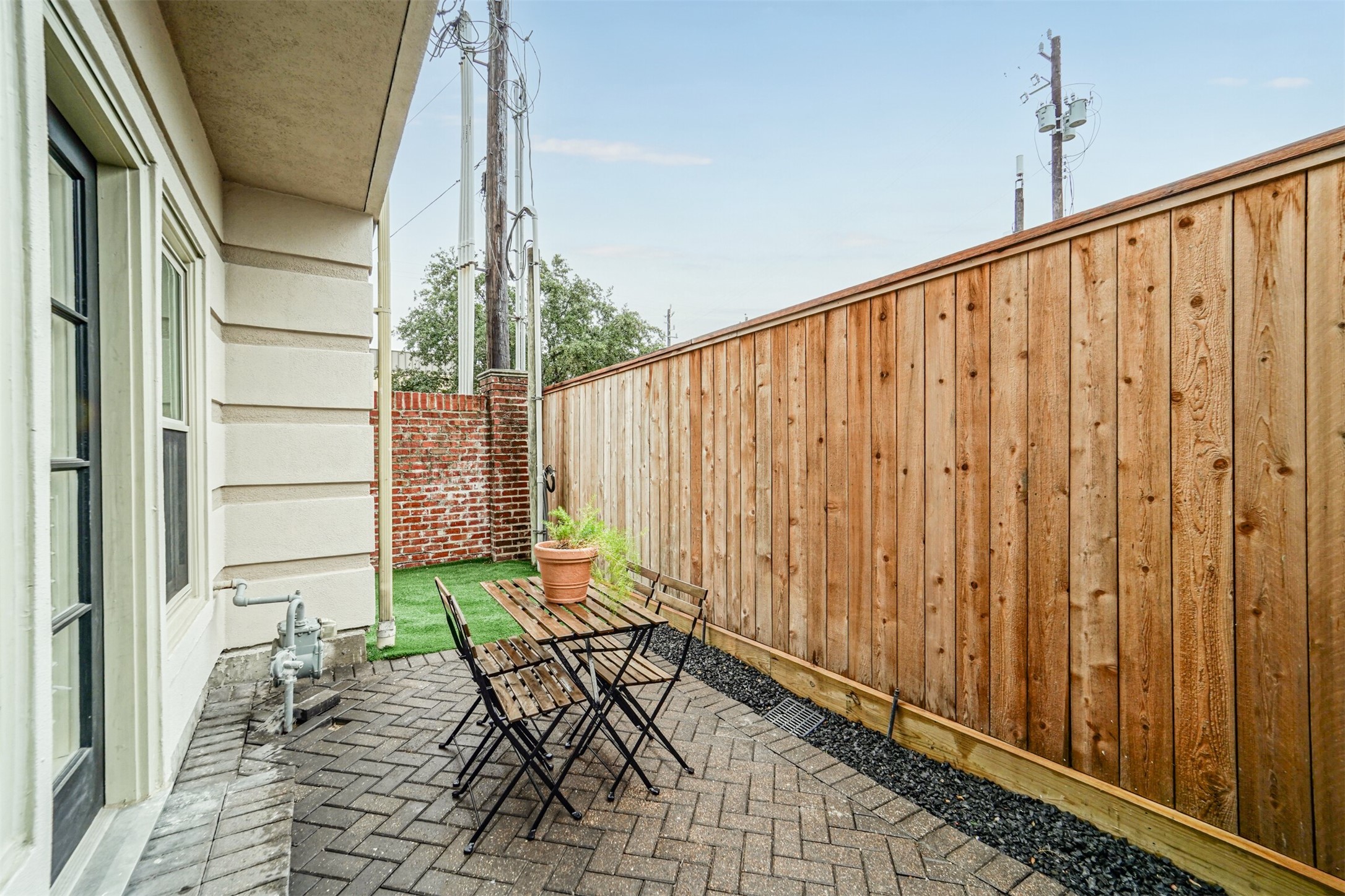 Hard to find paved patio area with newly replaced fence.