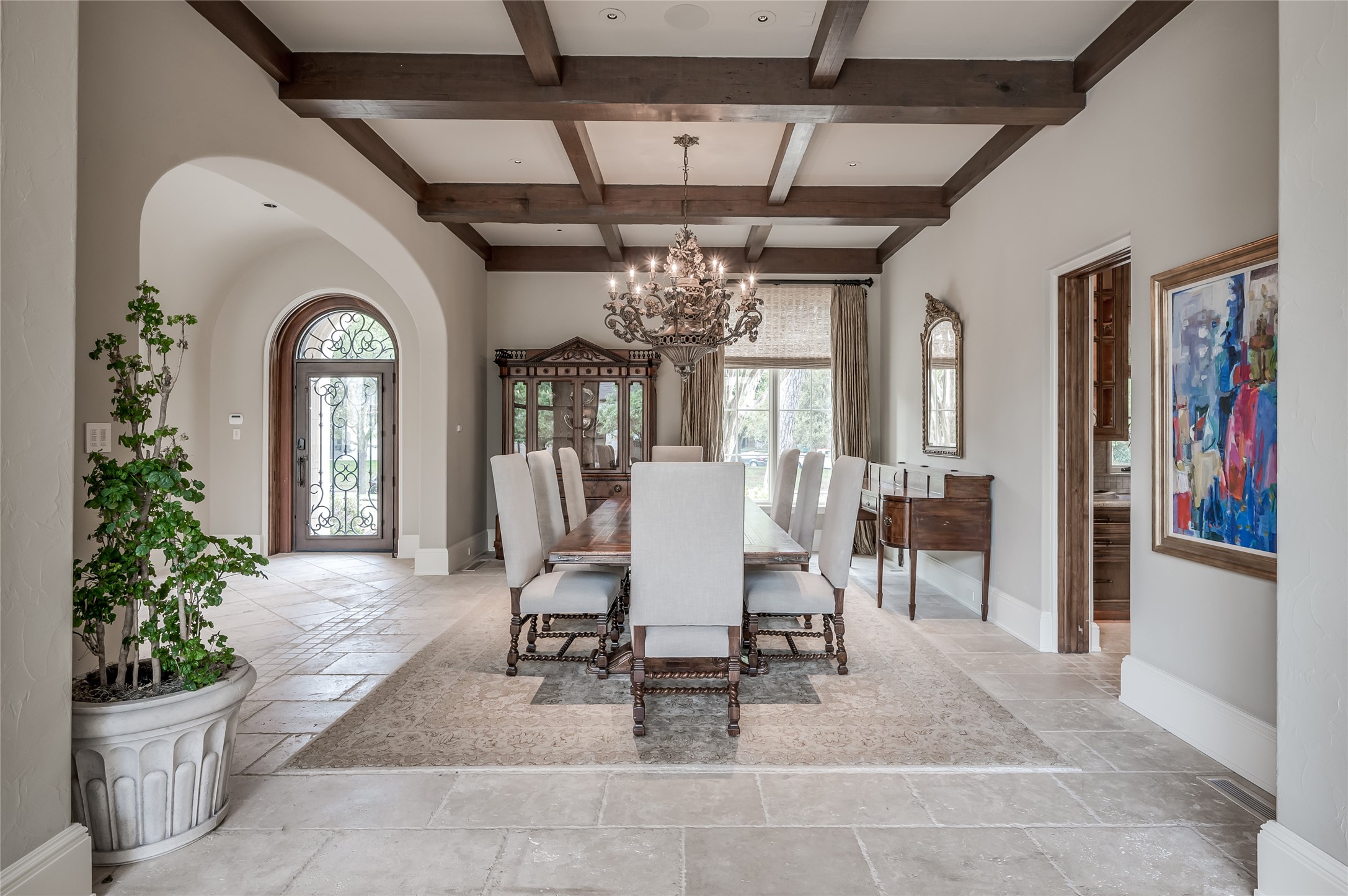 [Dining Room - 21x15]
The dining room has a coffered ceiling and shares the living room’s front views. Note alder wood pocket doors in closed position. Opening at right reveals the butler's pantry
