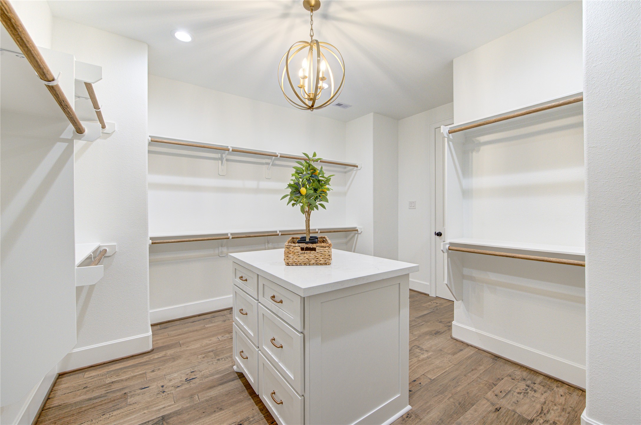 The walk-in wardrobe for the primary bedroom is designed with organization and space for your most discerning buyer.