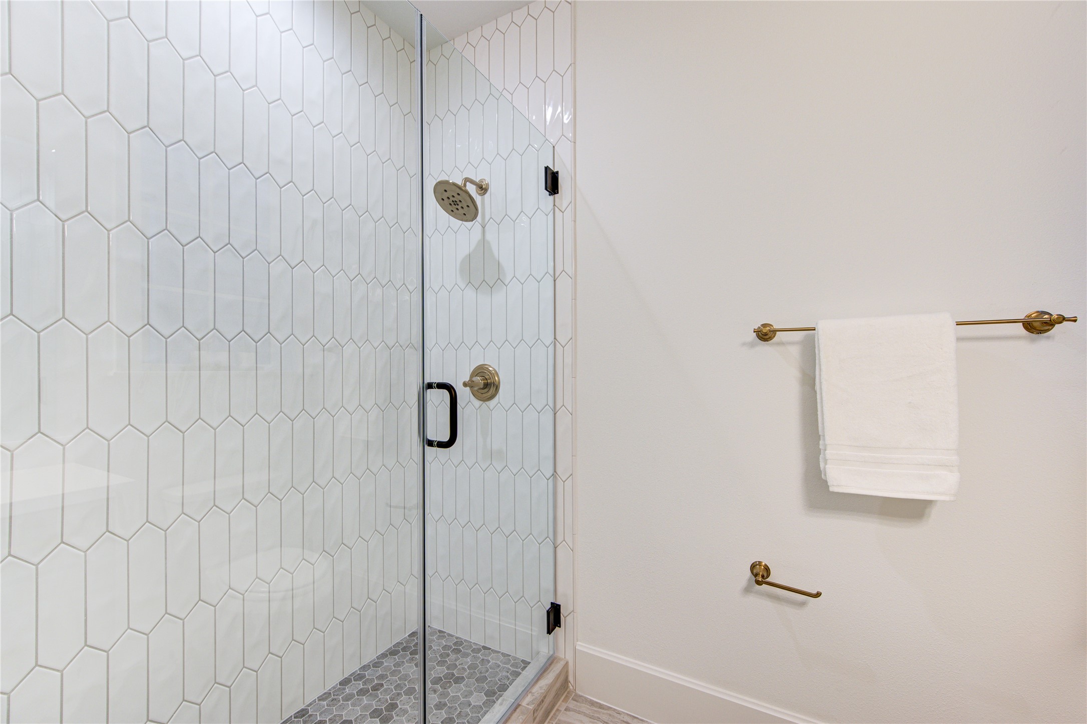 The 3rd bathroom boasts a modern walk-in shower with frameless shower doors.