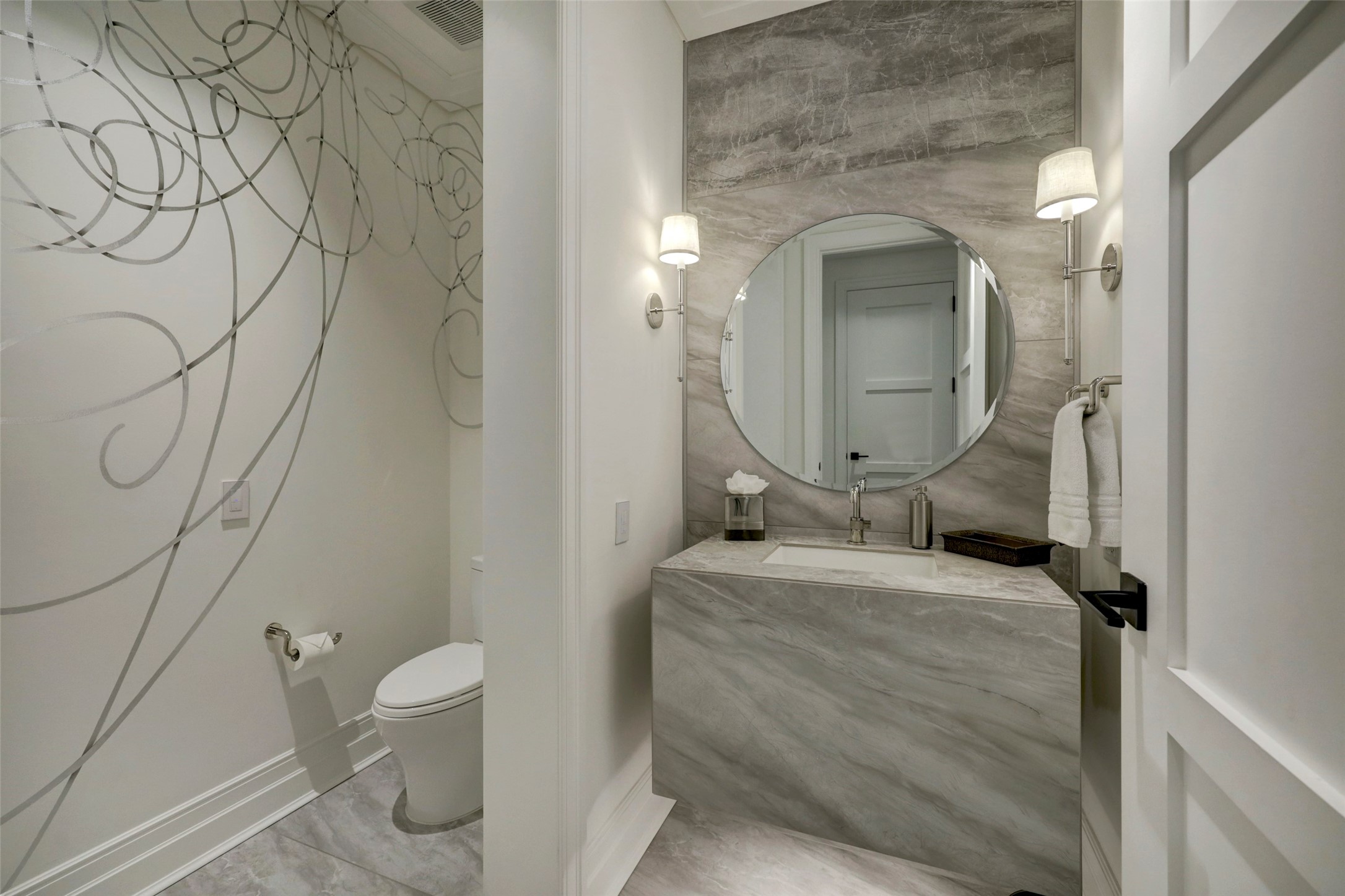 The Powder Bath includes a floating stone vanity, custom hardware and lighting, plus a whimsical mural.