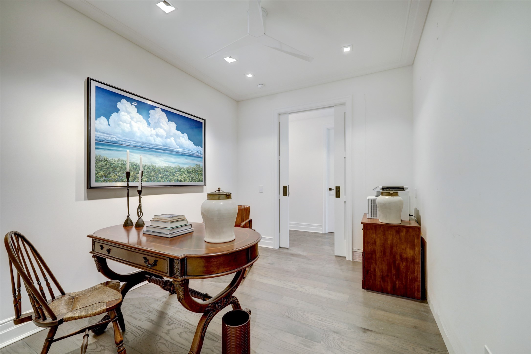 The Study has wide plank wood floors, pocket doors for privacy, and access to the Guest Bath.