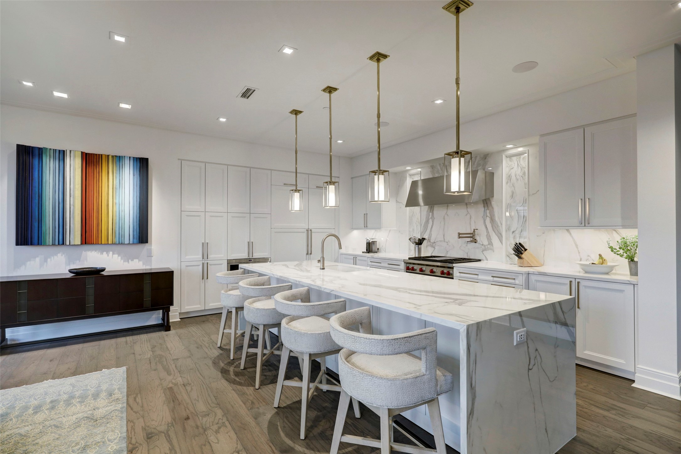 The sumptuous Kitchen features a waterfall island with seating for four.  The island, the counters and backsplash are all of quartz with magnificent movement and colors.