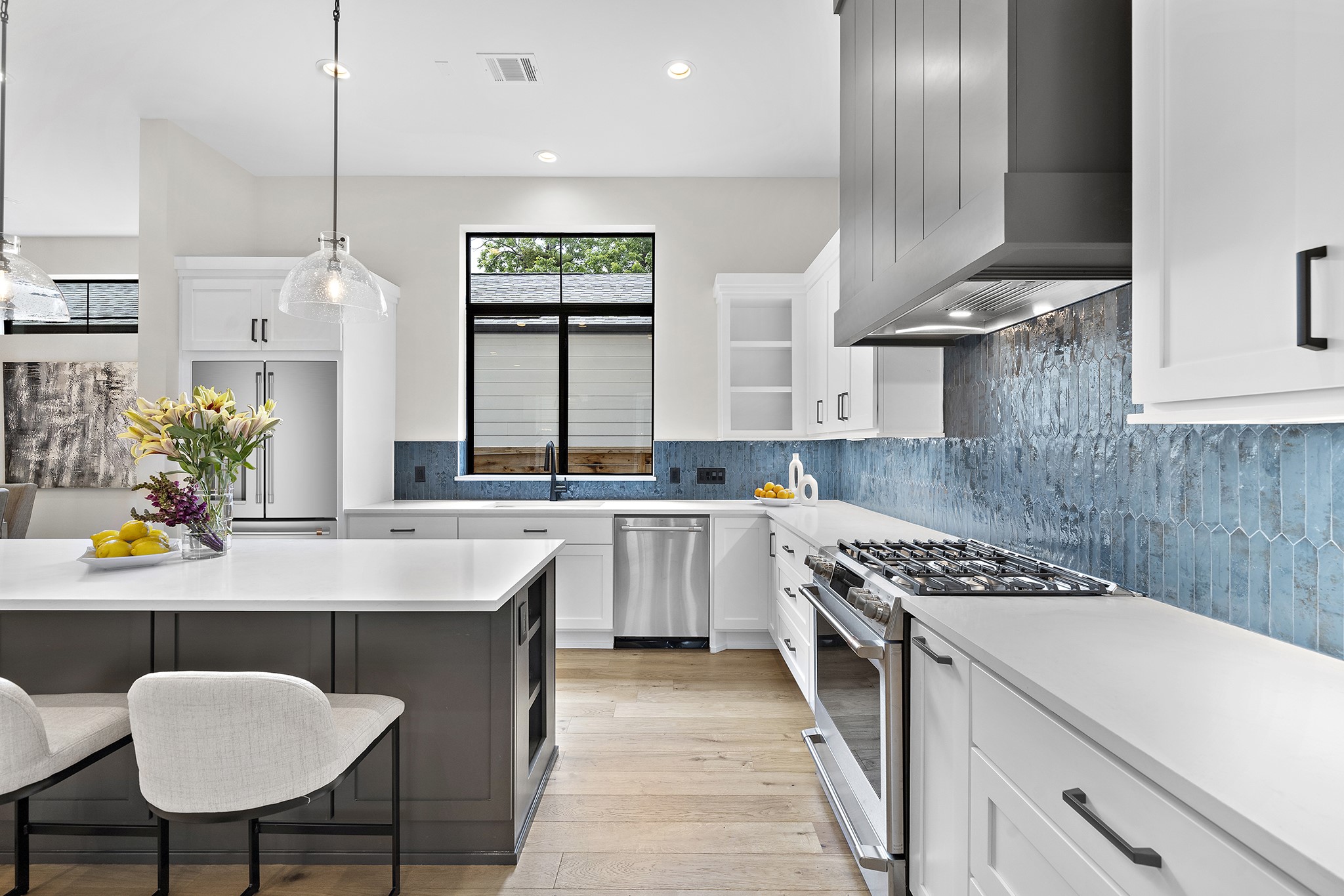 Sleek white shaker style cabinets pop against the gorgeous moroccan blue tile backsplash.